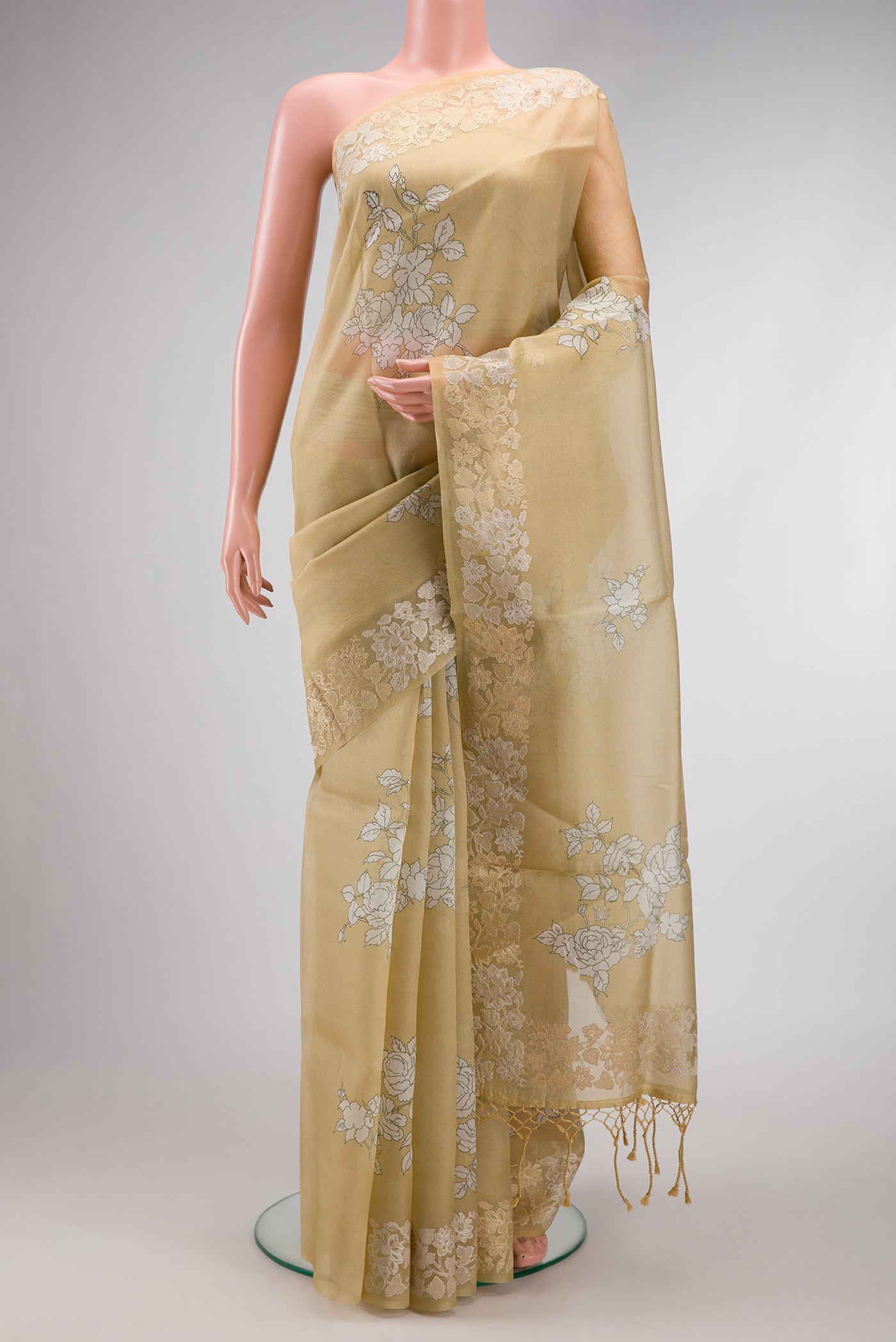 Beige Dual Tone Organza Silk Saree with Printed design on the body and Embroidery Border.  displayed on a mannequin