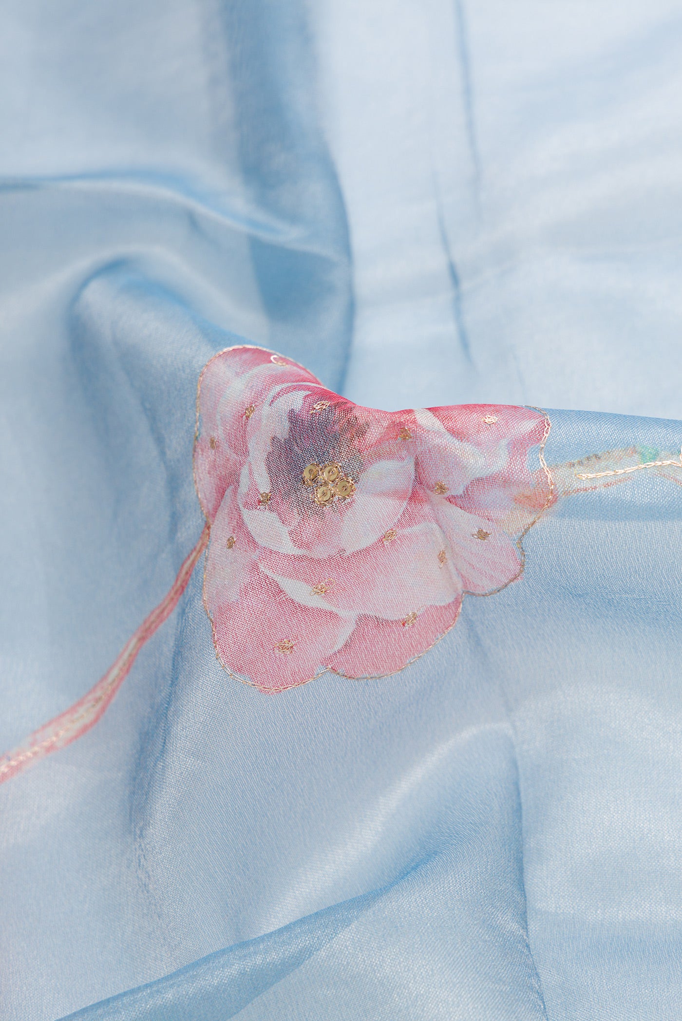 Close up of Grey Dual Tone Organza Silk Saree with Embroidery on the body and Embroidery Border.  displaying folds