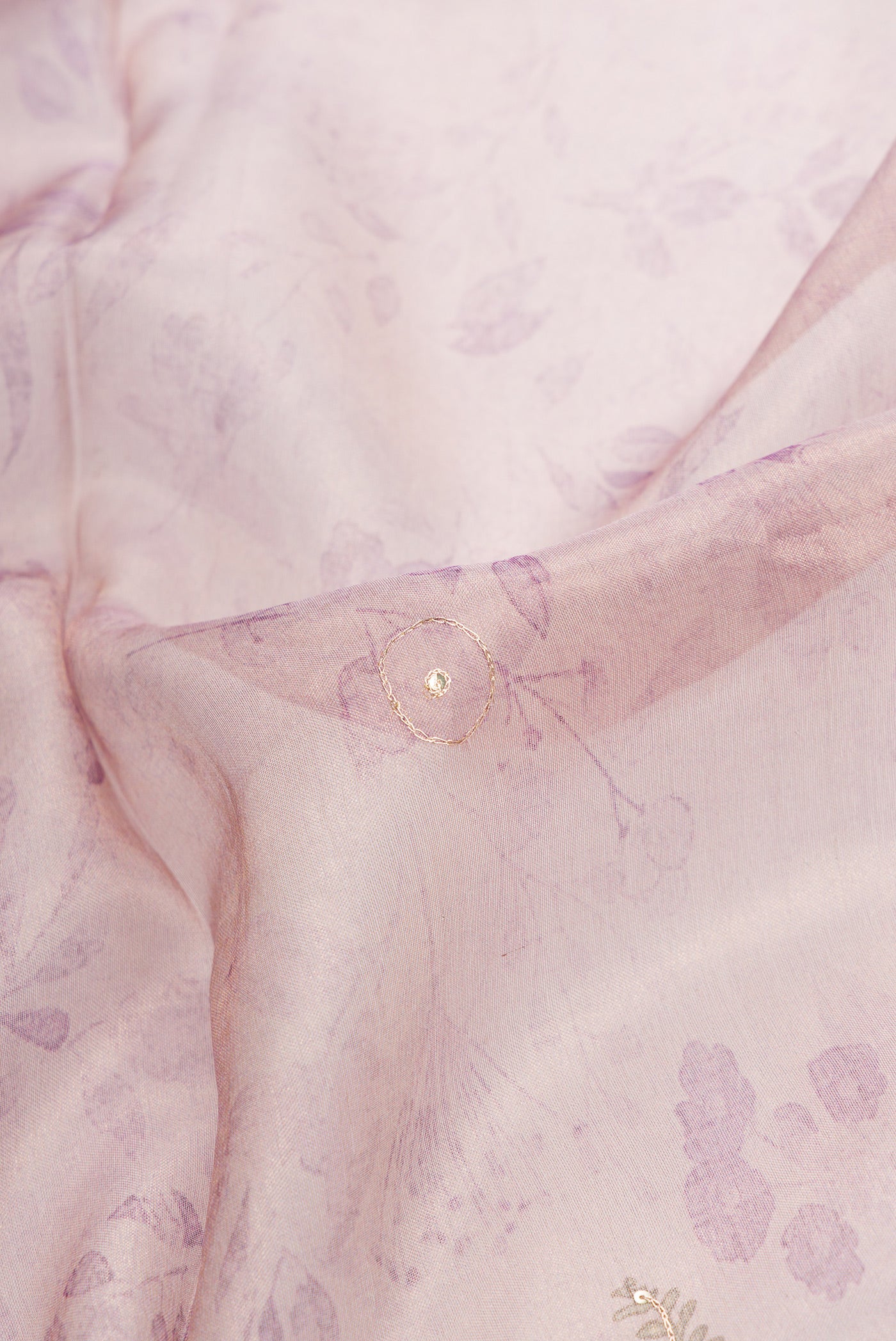 Close up of Rose Gold Dual Tone Organza Silk Saree with Embroidery on the body and Embroidery Border.  displaying folds