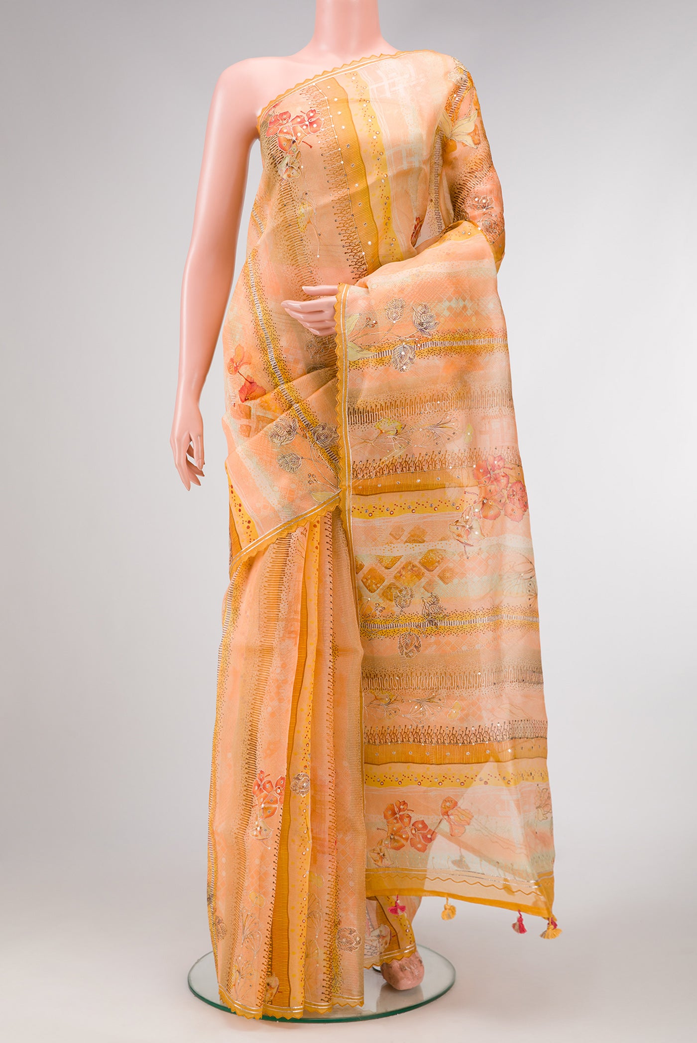 Peach Dual Tone Organza Silk Saree with Embroidery on the body and Embroidery Border.  displayed on a mannequin