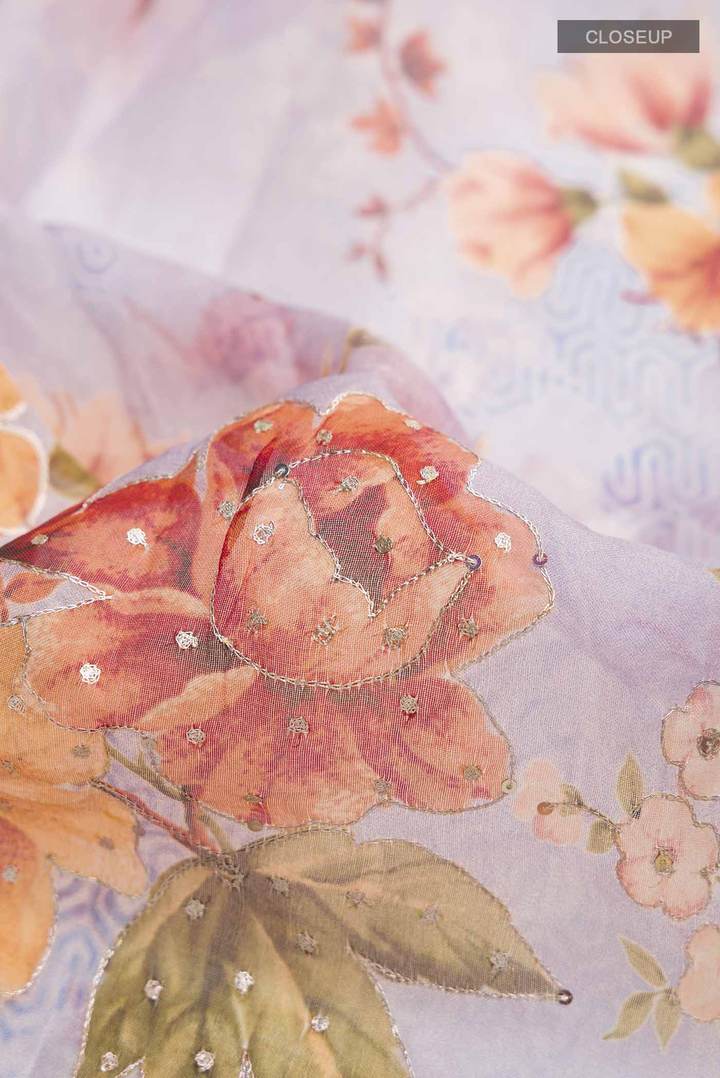 Close up of Lavender Organza Silk Saree with Embroidery on the body and Without Border displaying folds