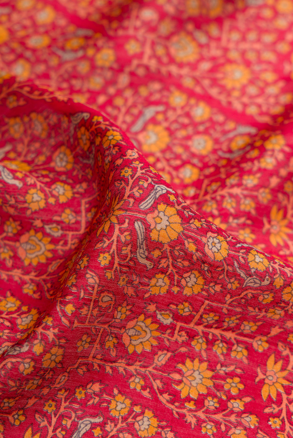 Close up of Maroon Dual Tone Tussar Silk Saree with Printed design on the body and Fancy Border.  displaying folds