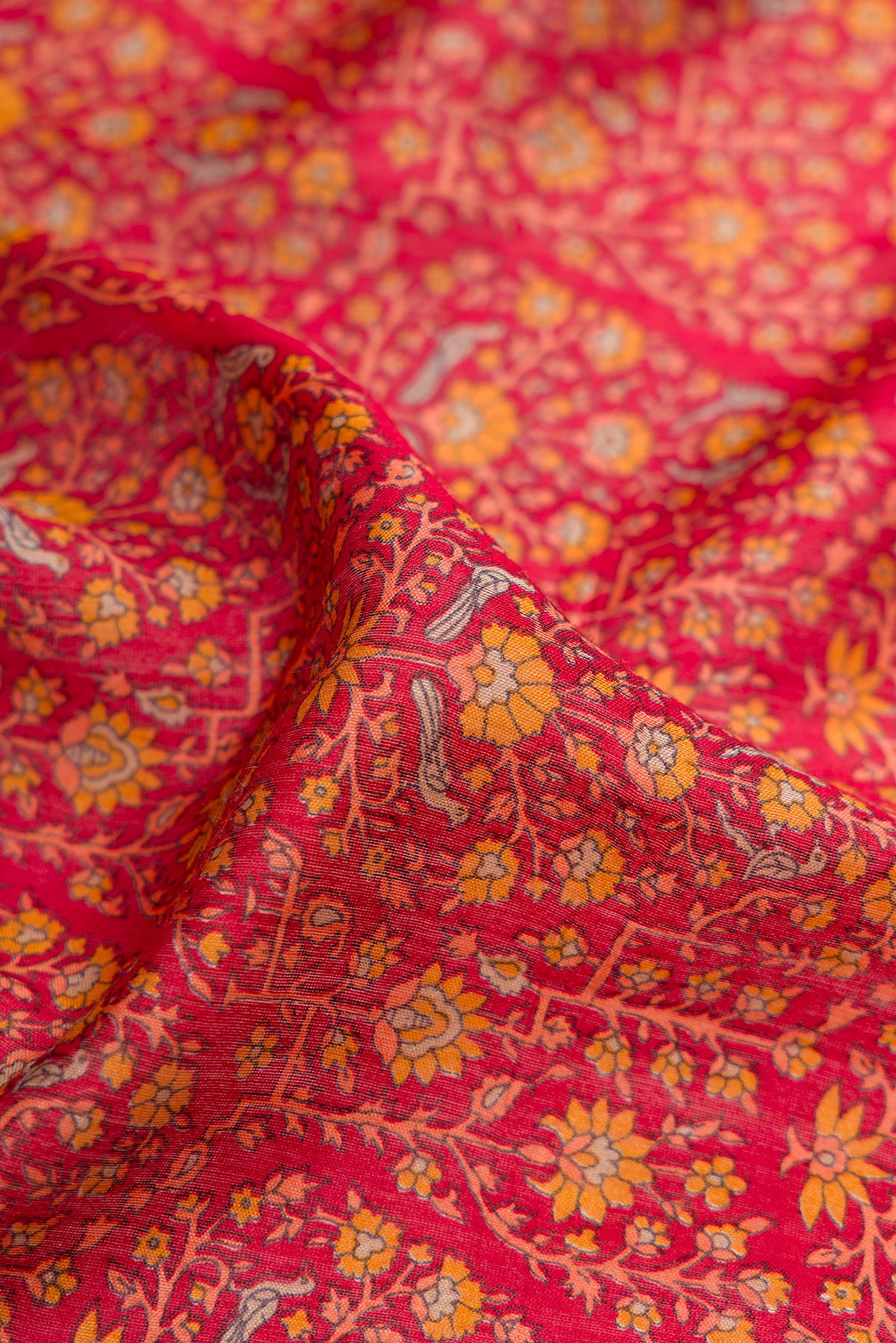 Close up of Maroon Dual Tone Tussar Silk Saree with Printed design on the body and Fancy Border.  displaying folds