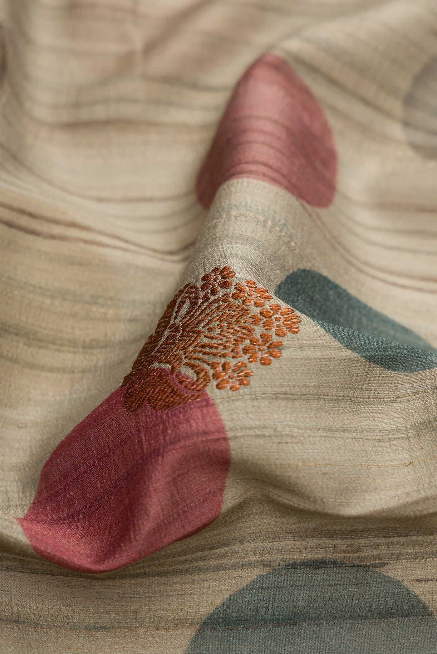 Close up of Grey Dual Tone Tussar Silk Saree with Printed design on the body and Fancy Border.  displaying folds