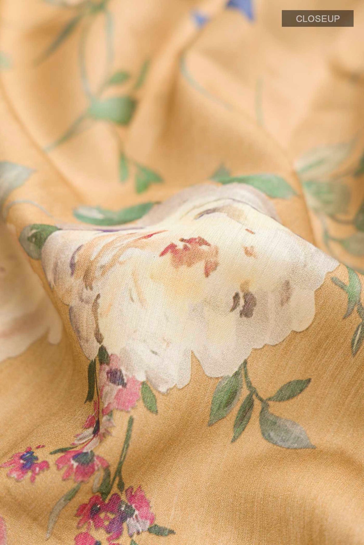 Close up of Brown Bhagalpuri Tussar Silk Saree with Floral Print on the body and Thin Zari Line displaying folds