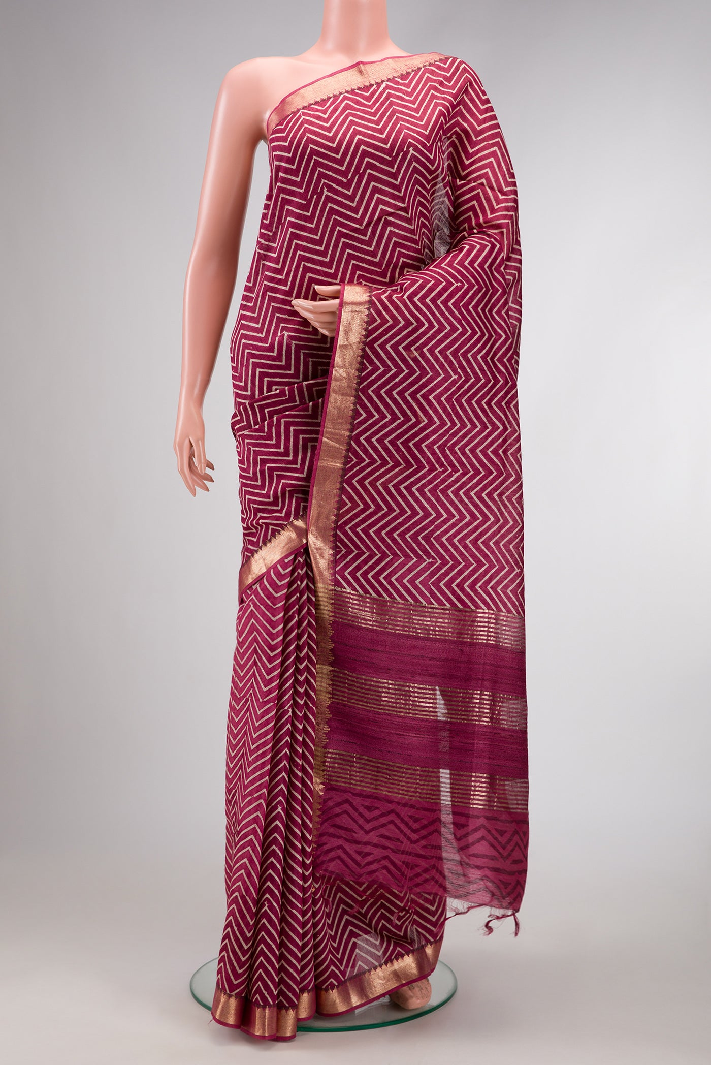 Burgundy Dual Tone Tussar Silk Saree with Printed design on the body and Zari Border.  displayed on a mannequin