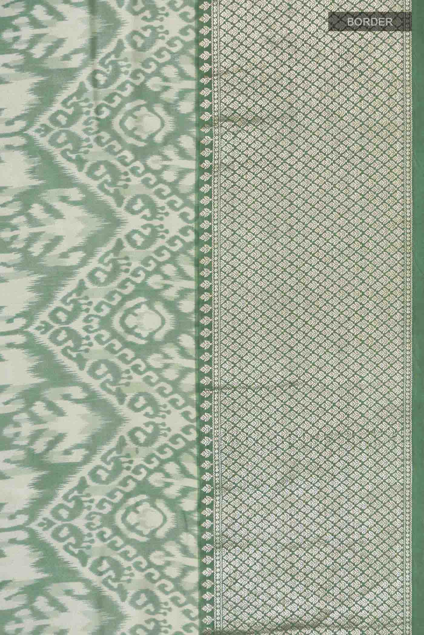 Border image of Green Tussar Silk Saree with Printed design on the body and Zari Border