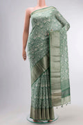 Green Tussar Silk Saree with Printed design on the body and Zari Border displayed on a mannequin