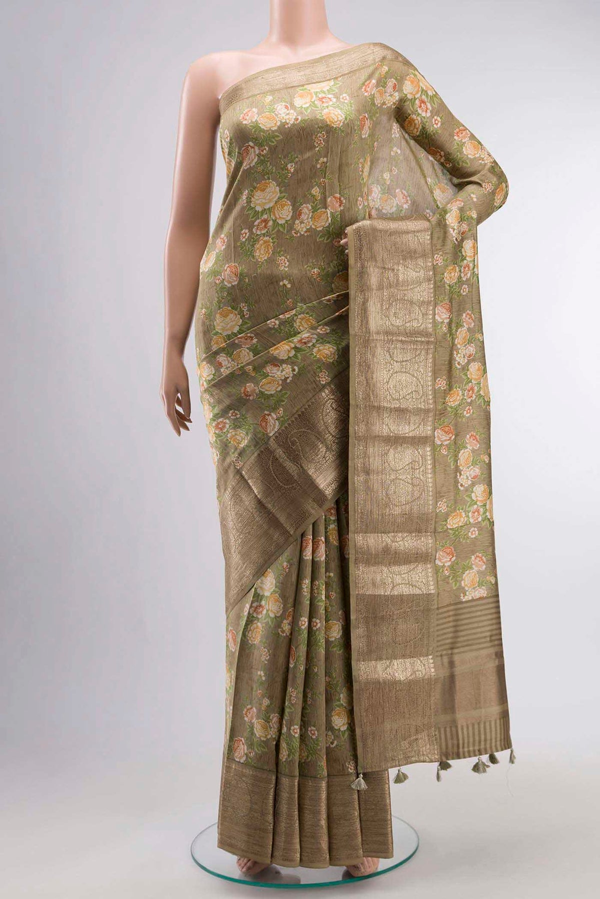 Brown Printed Silk Saree with Printed design on the body and Zari Border displayed on a mannequin