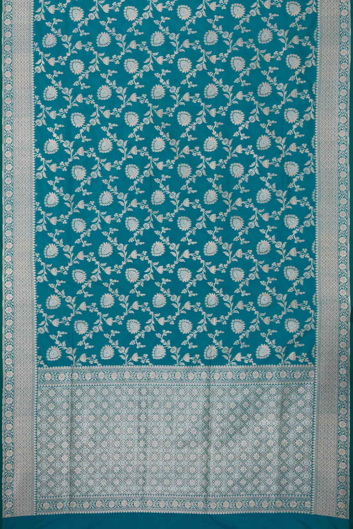 Flat view of Peacock Blue Dual Tone Blended Banarasi Silk Saree with Zari Brocade on the body and Zari Border. 