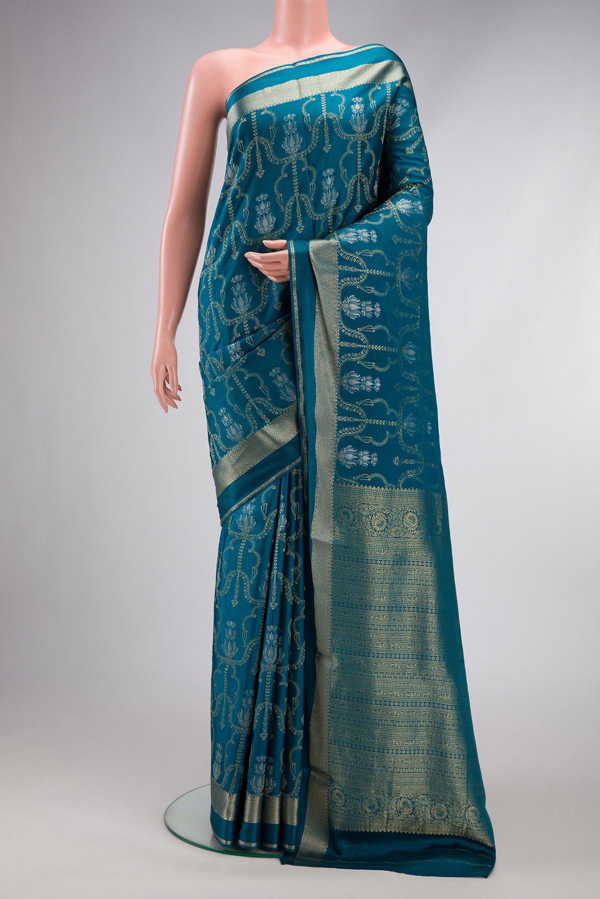Peacock Blue Dual Tone Mysore Crepe Saree with Zari Brocade on the body and Zari Border.  displayed on a mannequin