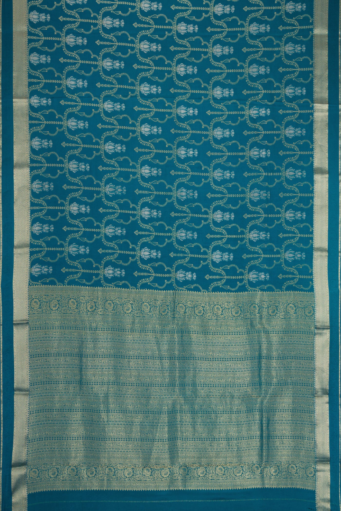 Flat view of Peacock Blue Dual Tone Mysore Crepe Saree with Zari Brocade on the body and Zari Border. 