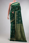 Bottle Green Dual Tone Banarasi Georgette Saree with Zari Brocade on the body and Zari Border.  displayed on a mannequin