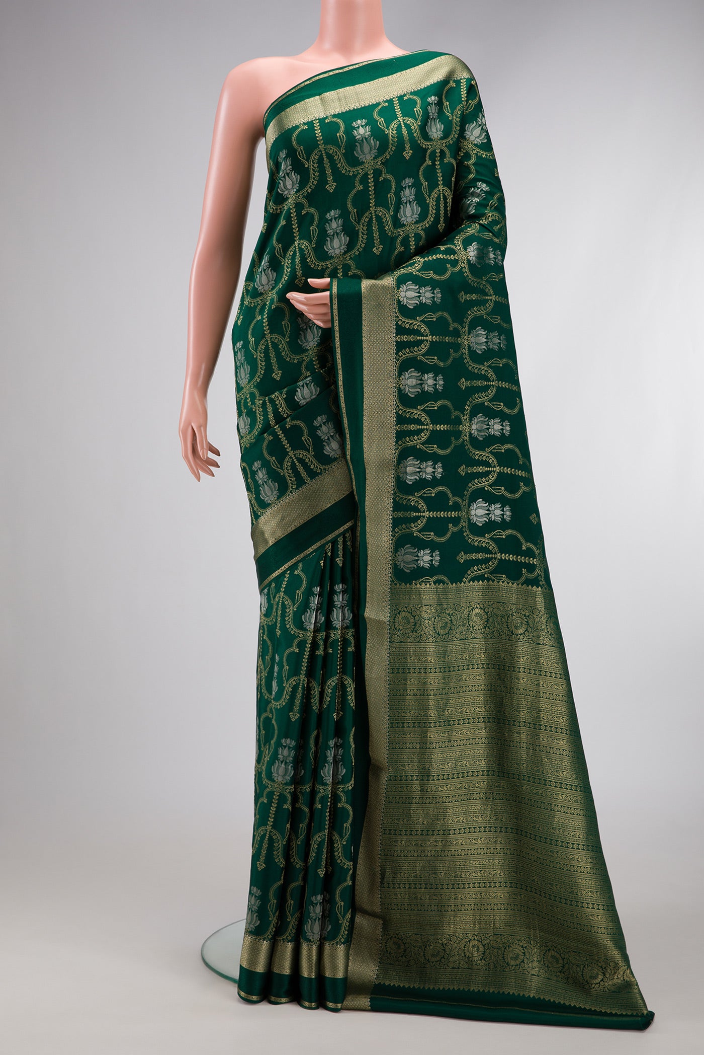 Bottle Green Dual Tone Banarasi Georgette Saree with Zari Brocade on the body and Zari Border.  displayed on a mannequin