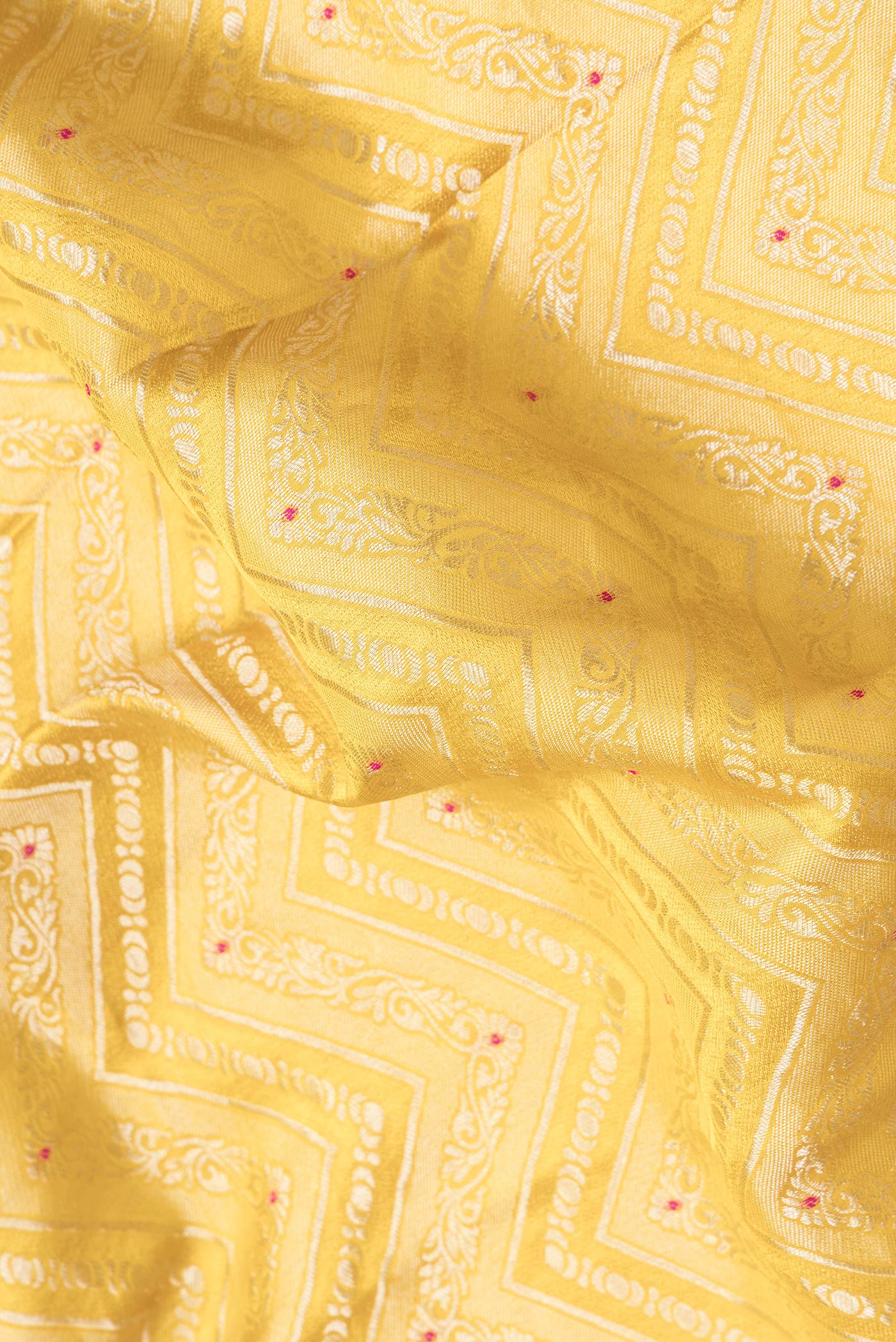 Close up of Yellow Dual Tone Banarasi Georgette Saree with Zari Brocade on the body and Zari Border.  displaying folds