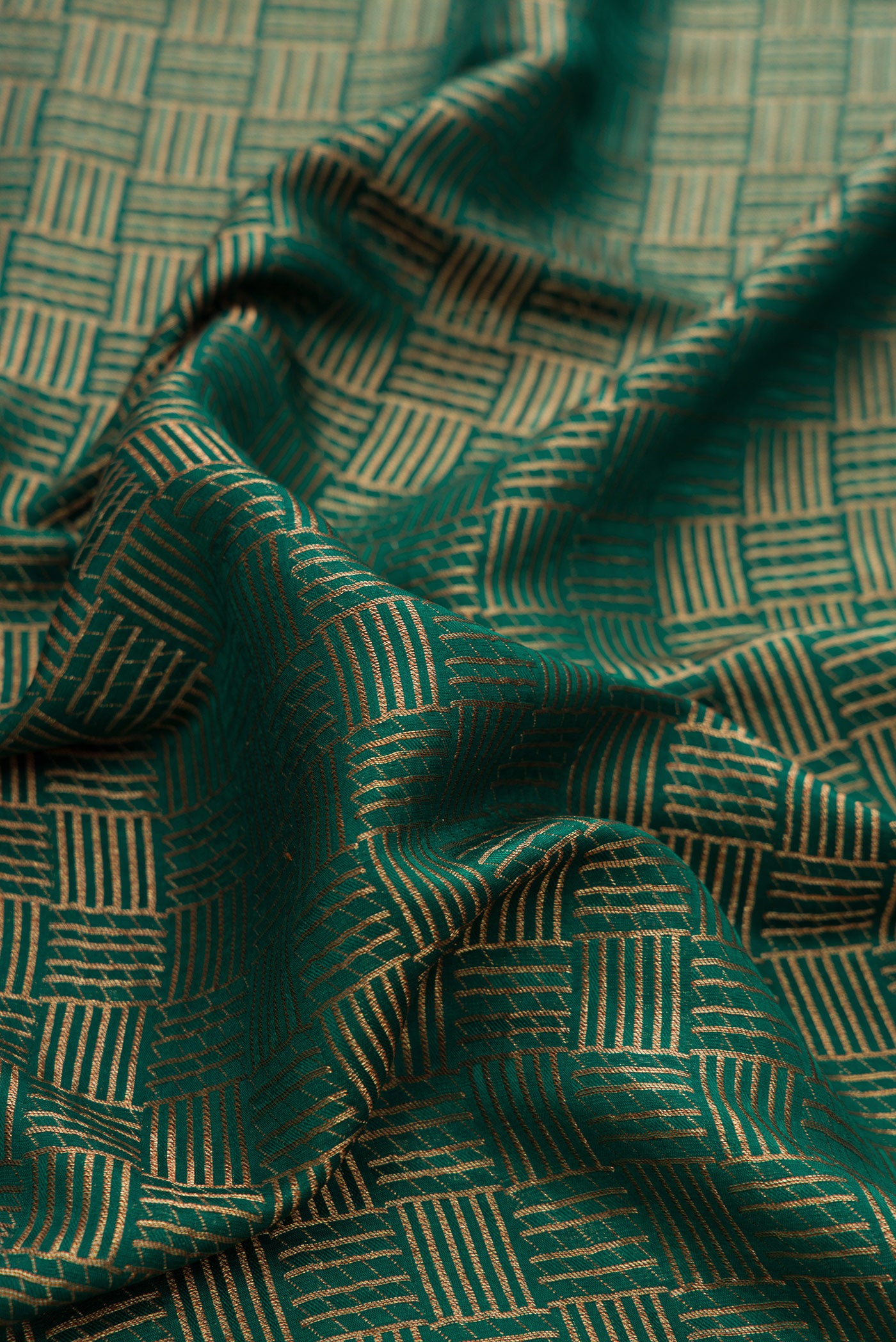 Close up of Bottle Green Dual Tone Mysore Crepe Saree with Zari Brocade on the body and Zari Border.  displaying folds
