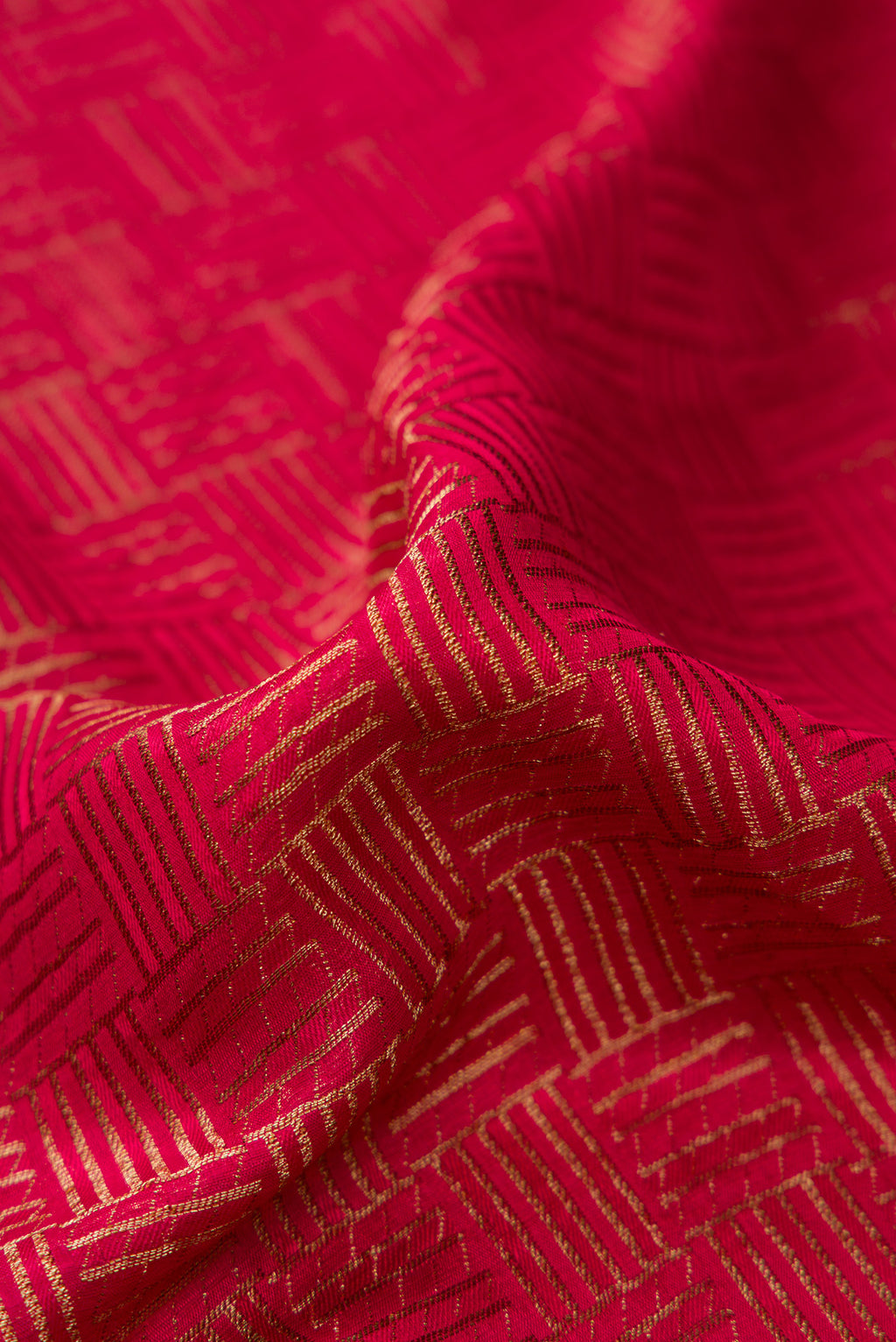 Close up of Dark Pink Mysore Crepe Saree with Zari Brocade on the body and Zari Border.  displaying folds