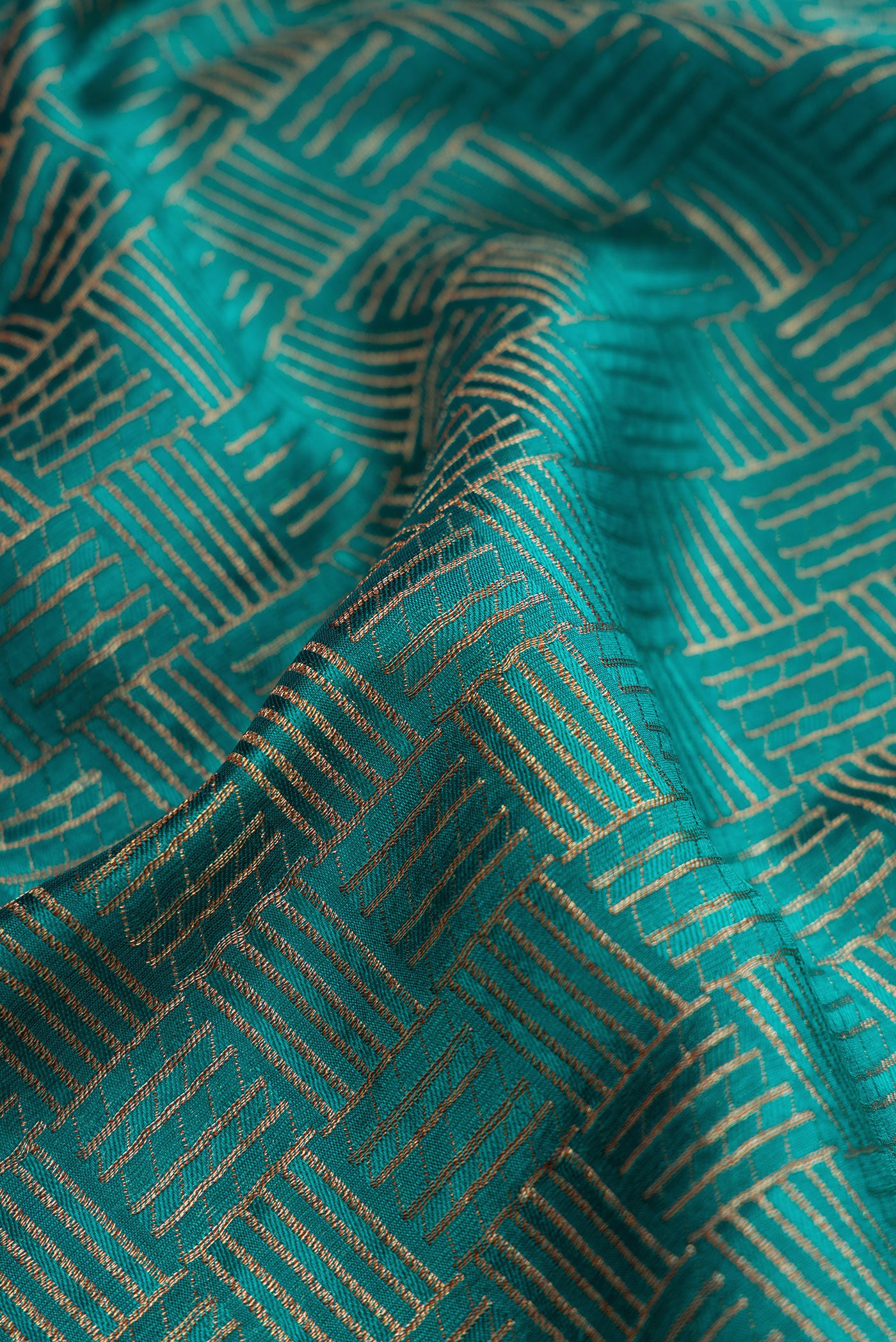 Close up of Green Dual Tone Banarasi Georgette Saree with Zari Brocade on the body and Zari Border.  displaying folds