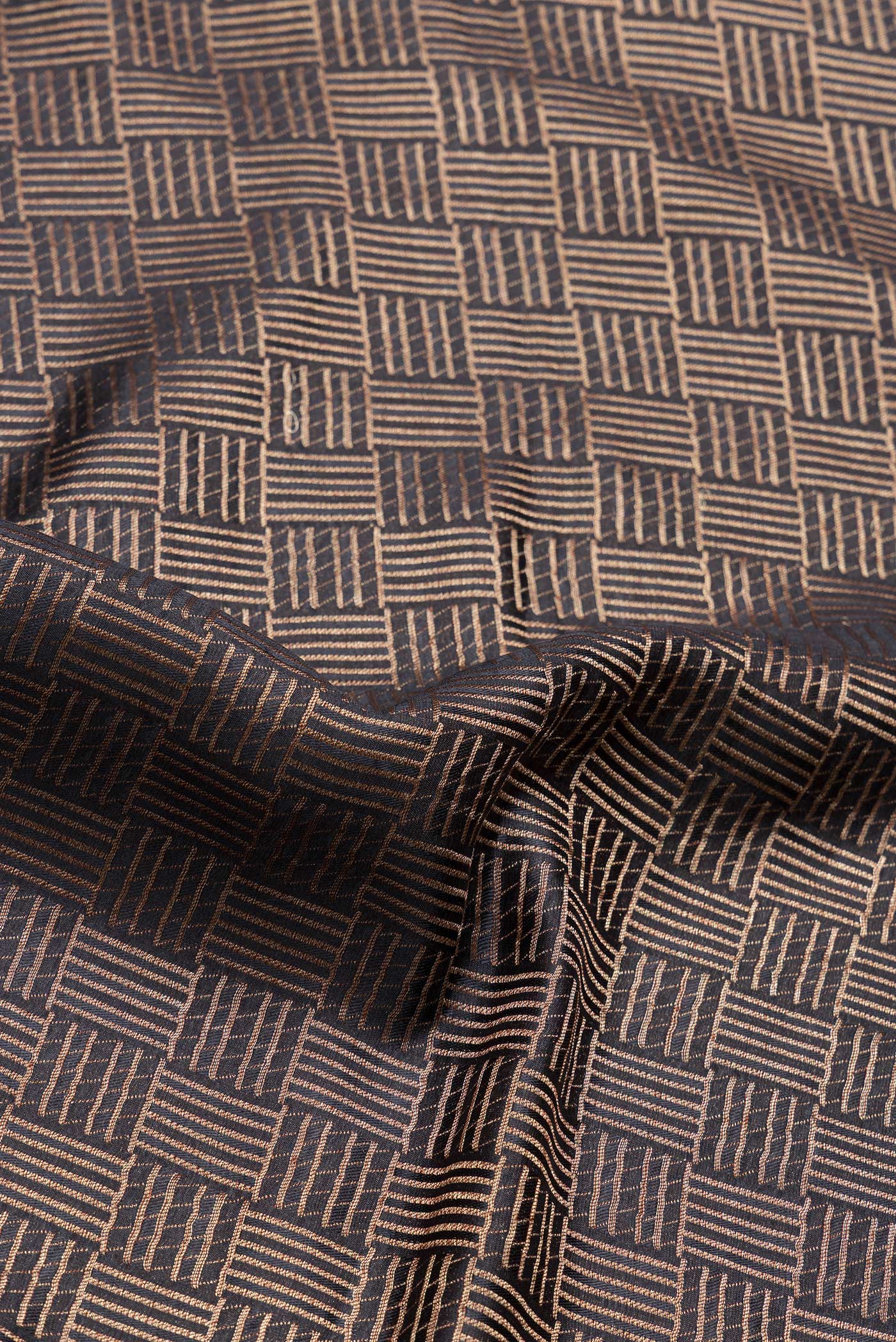 Close up of Black Dual Tone Tussar Silk Saree with Zari Brocade on the body and Zari Border.  displaying folds