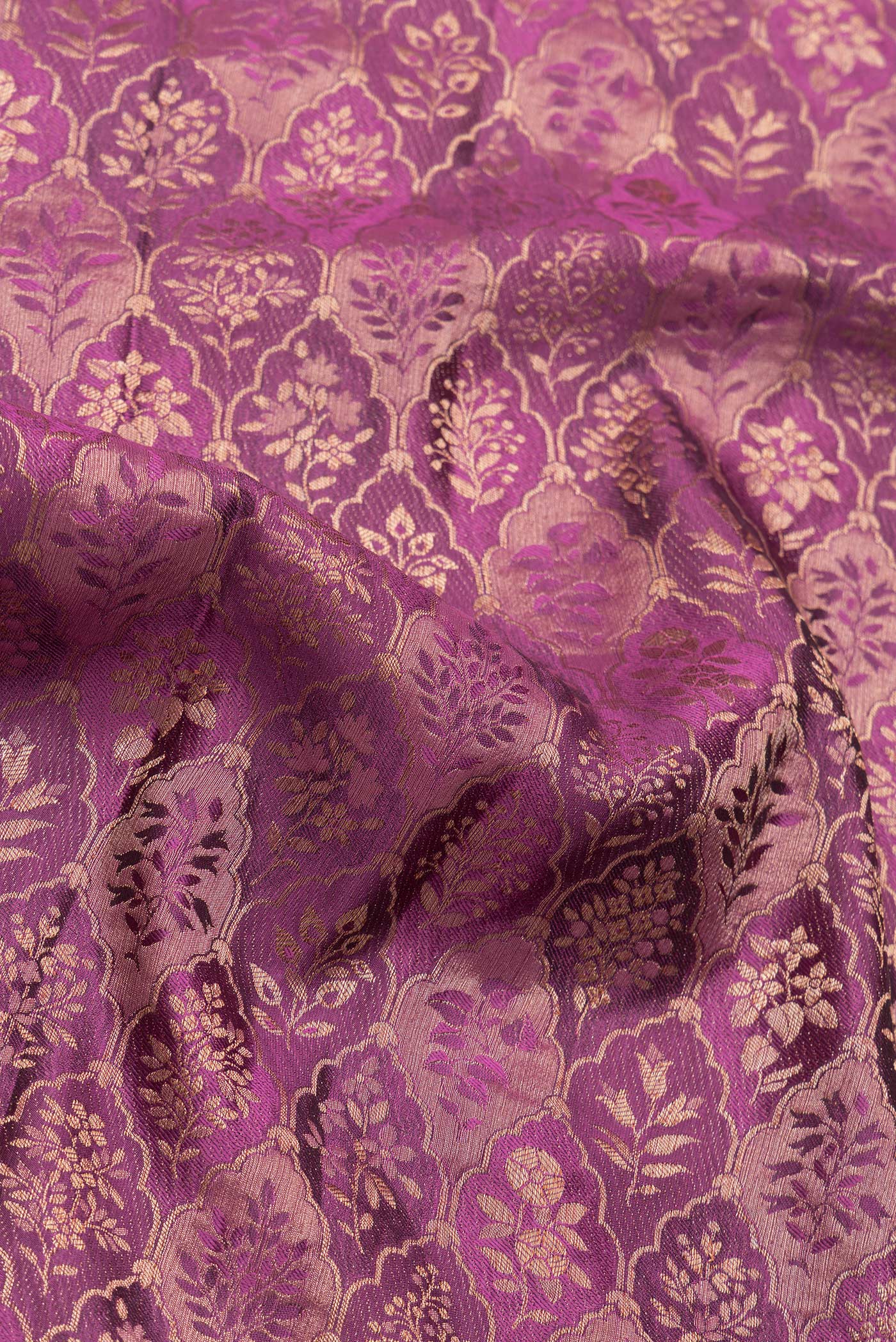 Close up of Magenta Dual Tone Banarasi Georgette Saree with Zari Brocade on the body and Zari Border.  displaying folds