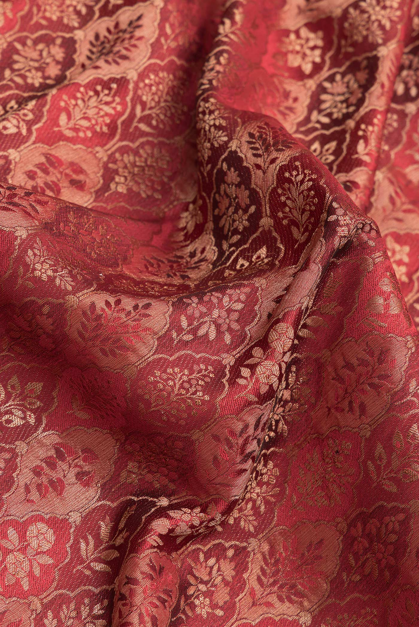 Close up of Maroon Dual Tone Banarasi Georgette Saree with Zari Brocade on the body and Zari Border.  displaying folds