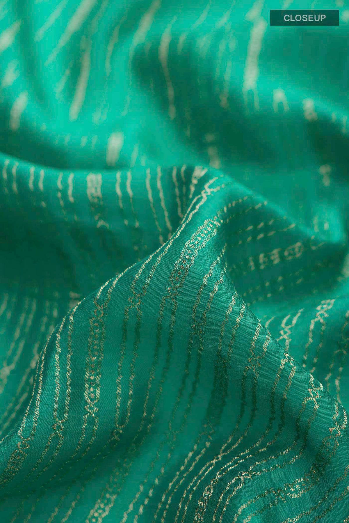 Close up of Teal Mysore Crepe Saree with Stripes on the body and Zari Border displaying folds