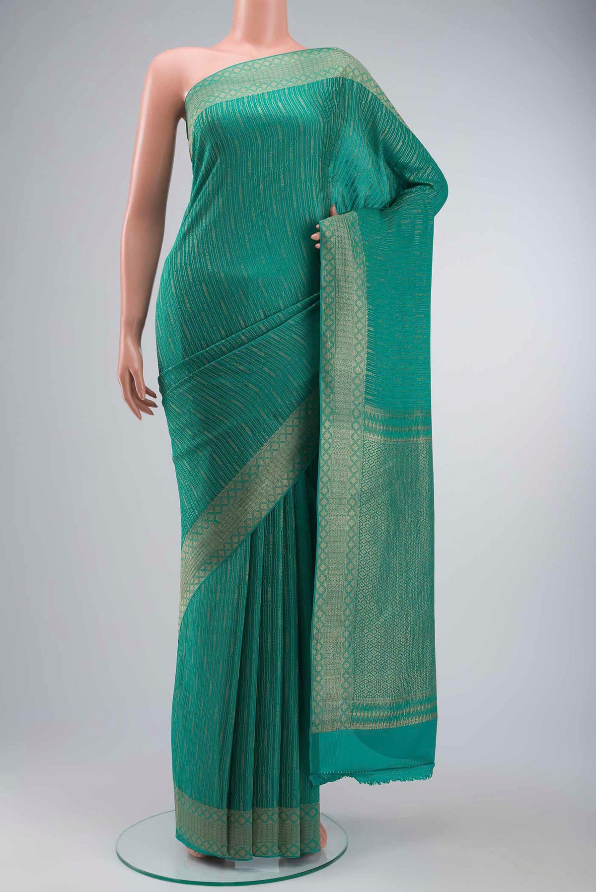 Teal Mysore Crepe Saree with Stripes on the body and Zari Border displayed on a mannequin