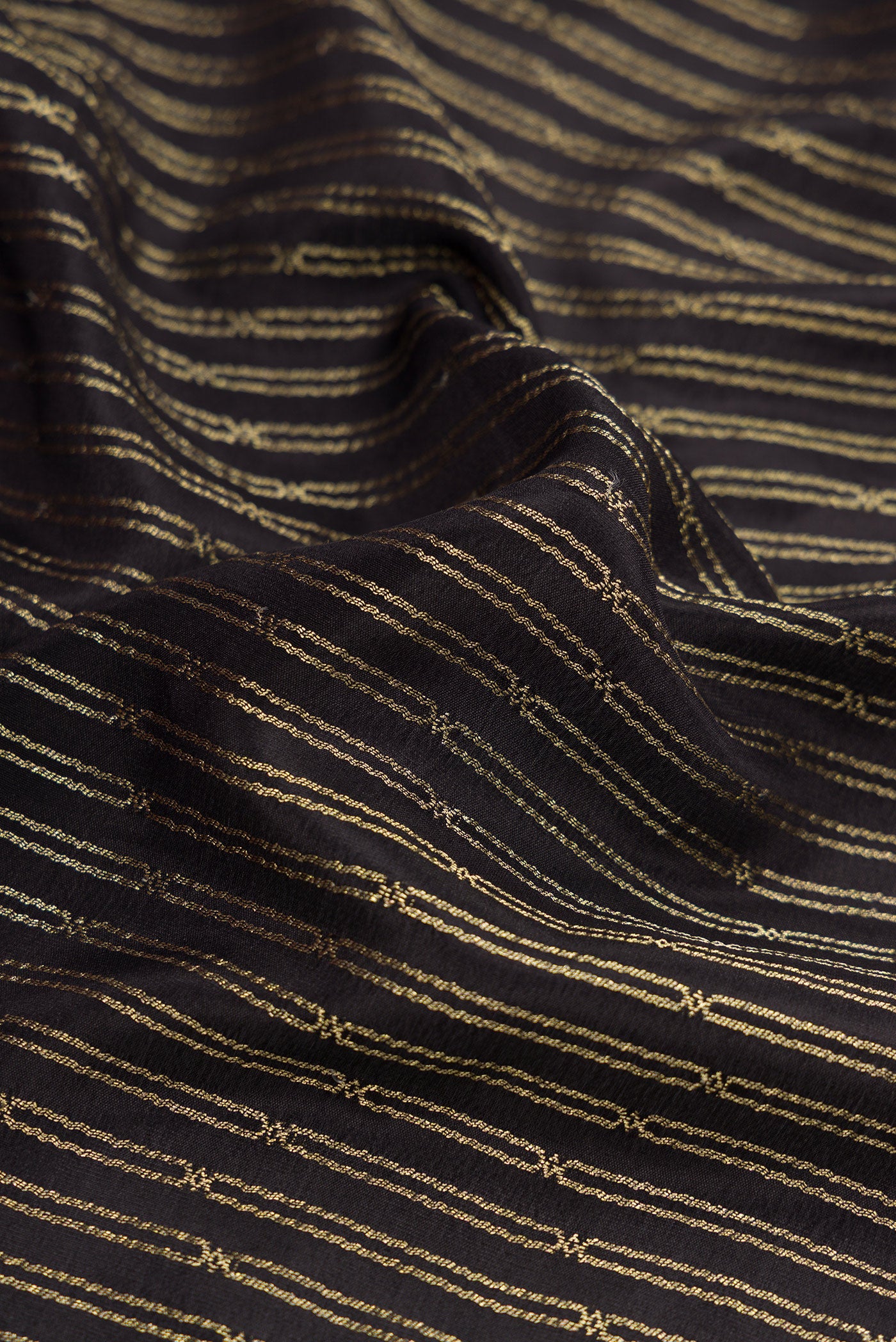 Close up of Black Mysore Crepe Saree with Stripes on the body and Zari Border.  displaying folds