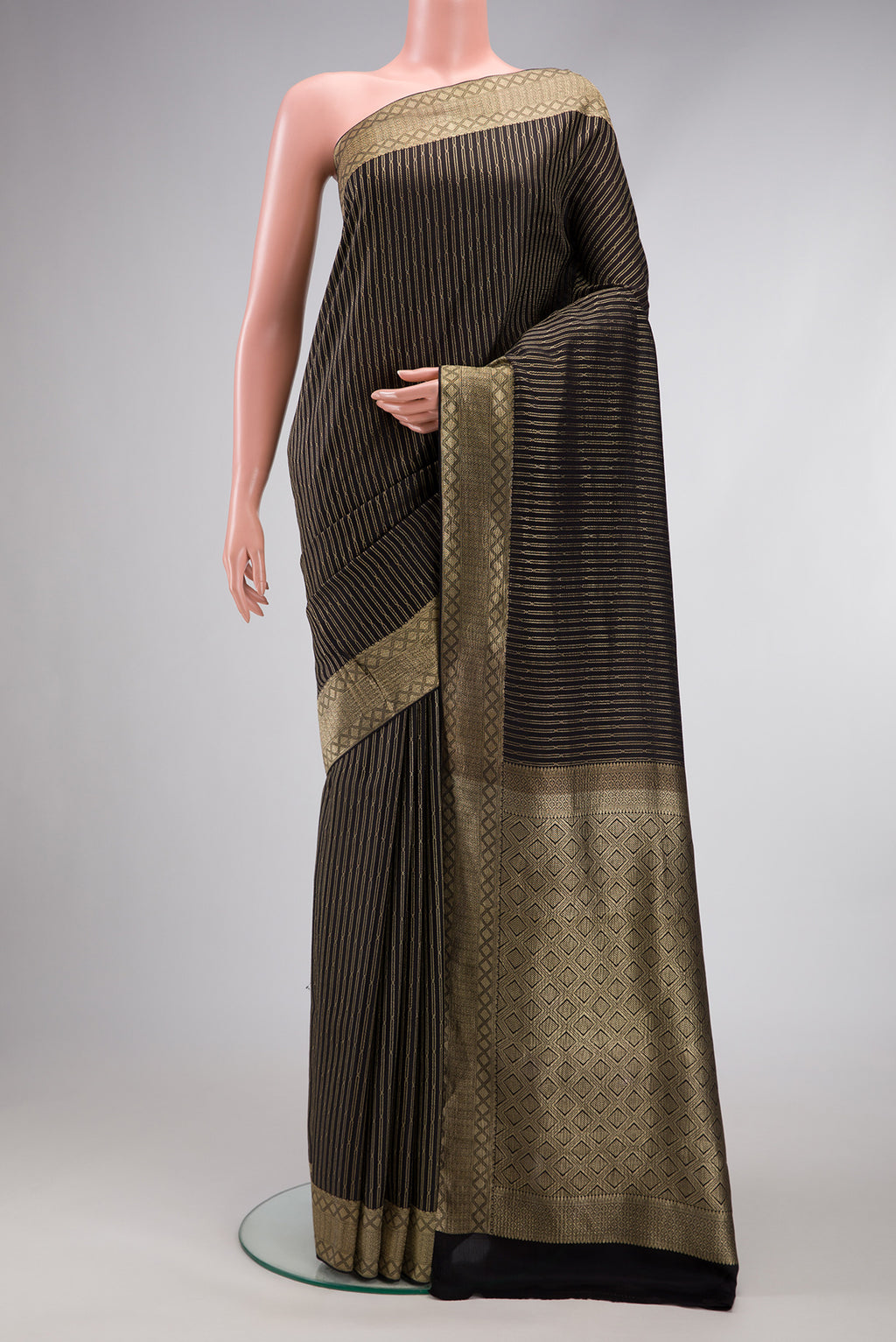 Black Mysore Crepe Saree with Stripes on the body and Zari Border.  displayed on a mannequin