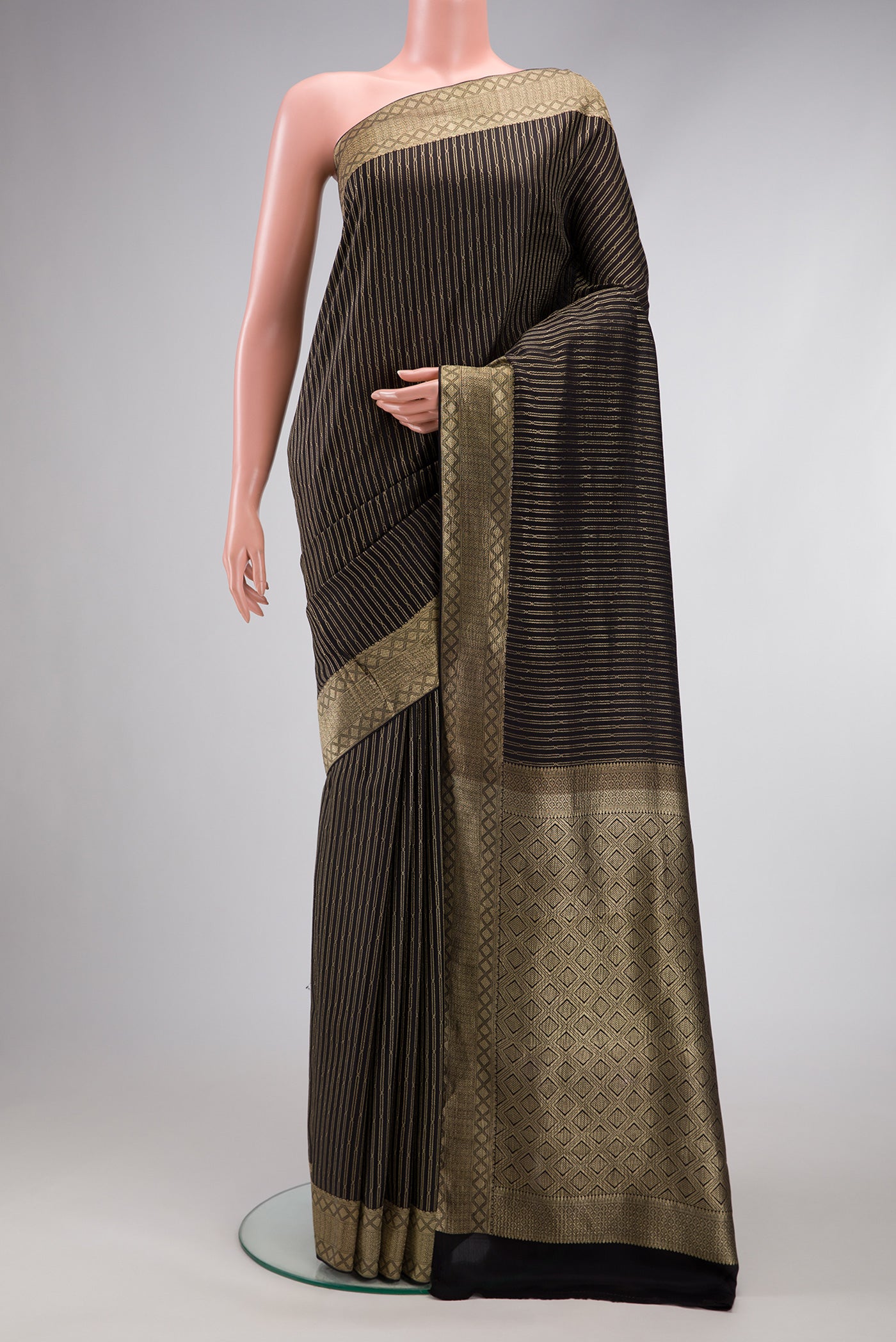 Black Mysore Crepe Saree with Stripes on the body and Zari Border.  displayed on a mannequin