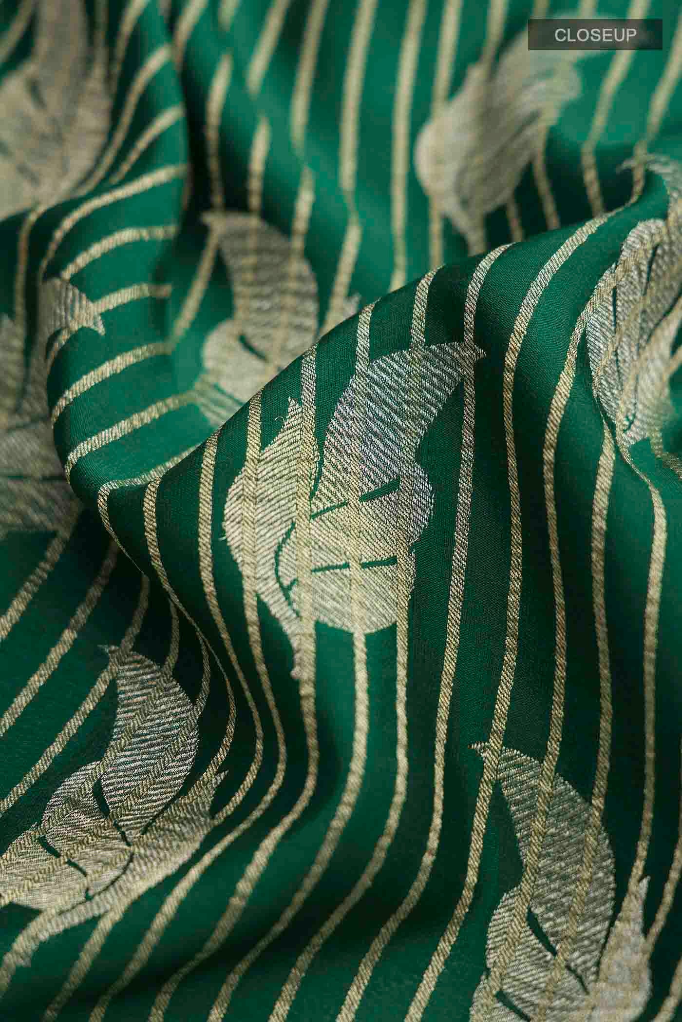 Close up of Green Mysore Crepe Saree with Zari Butta on the body and Zari Border displaying folds