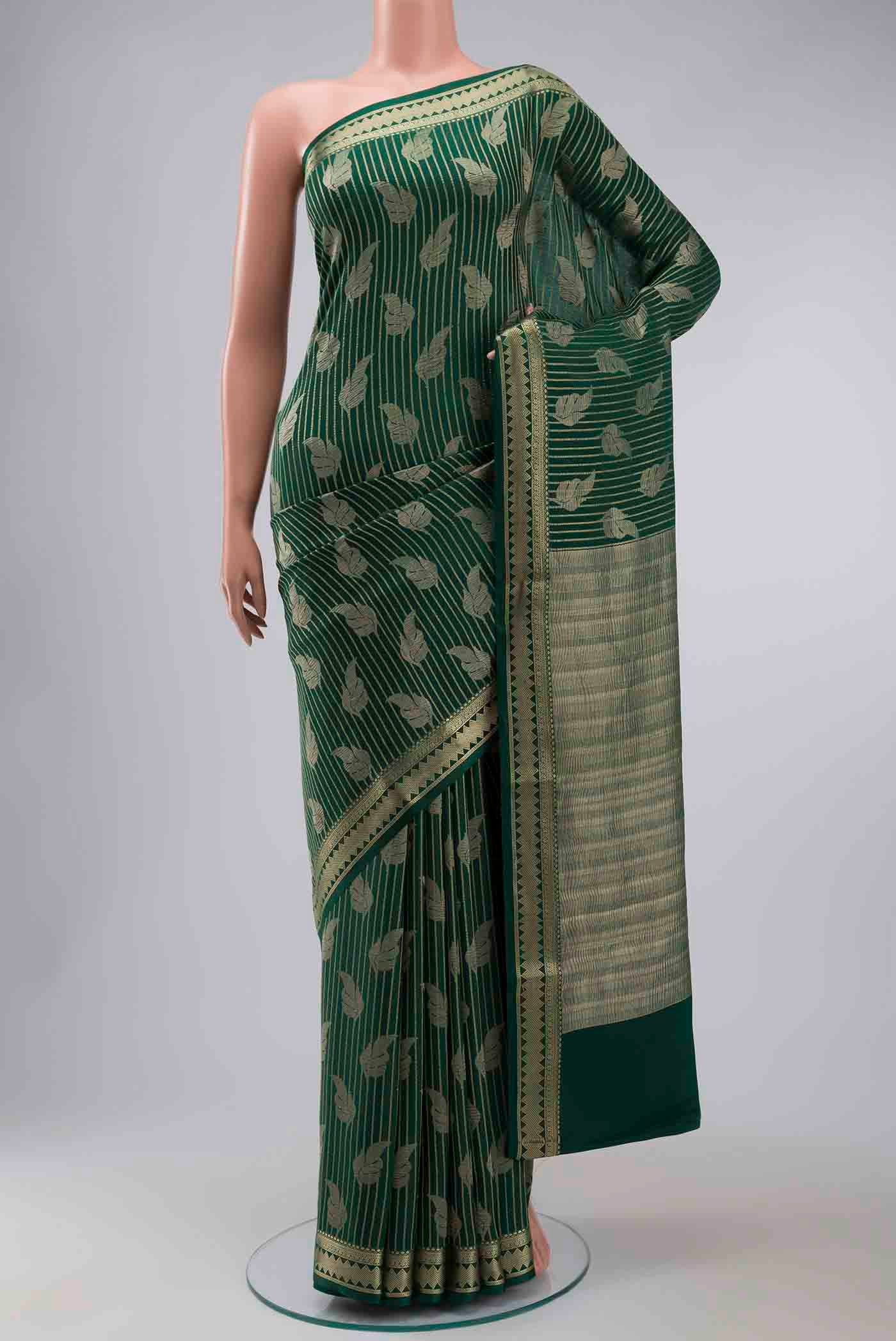 Green Mysore Crepe Saree with Zari Butta on the body and Zari Border displayed on a mannequin