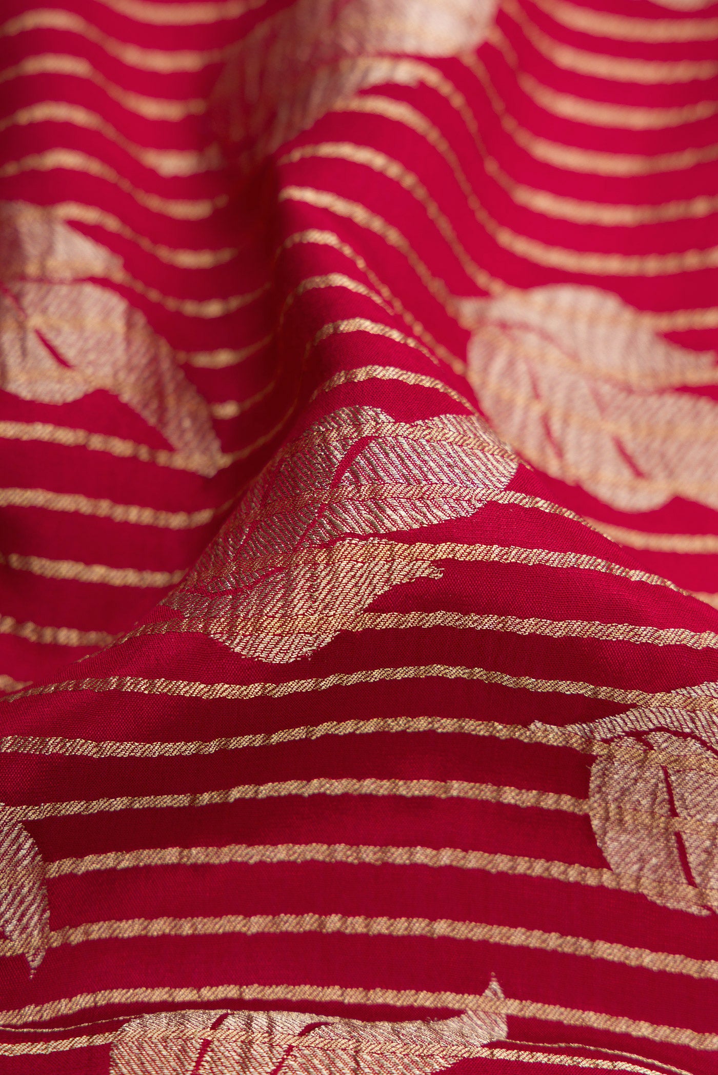 Close up of Maroon Banarasi Georgette Saree with Zari Brocade on the body and Zari Border.  displaying folds