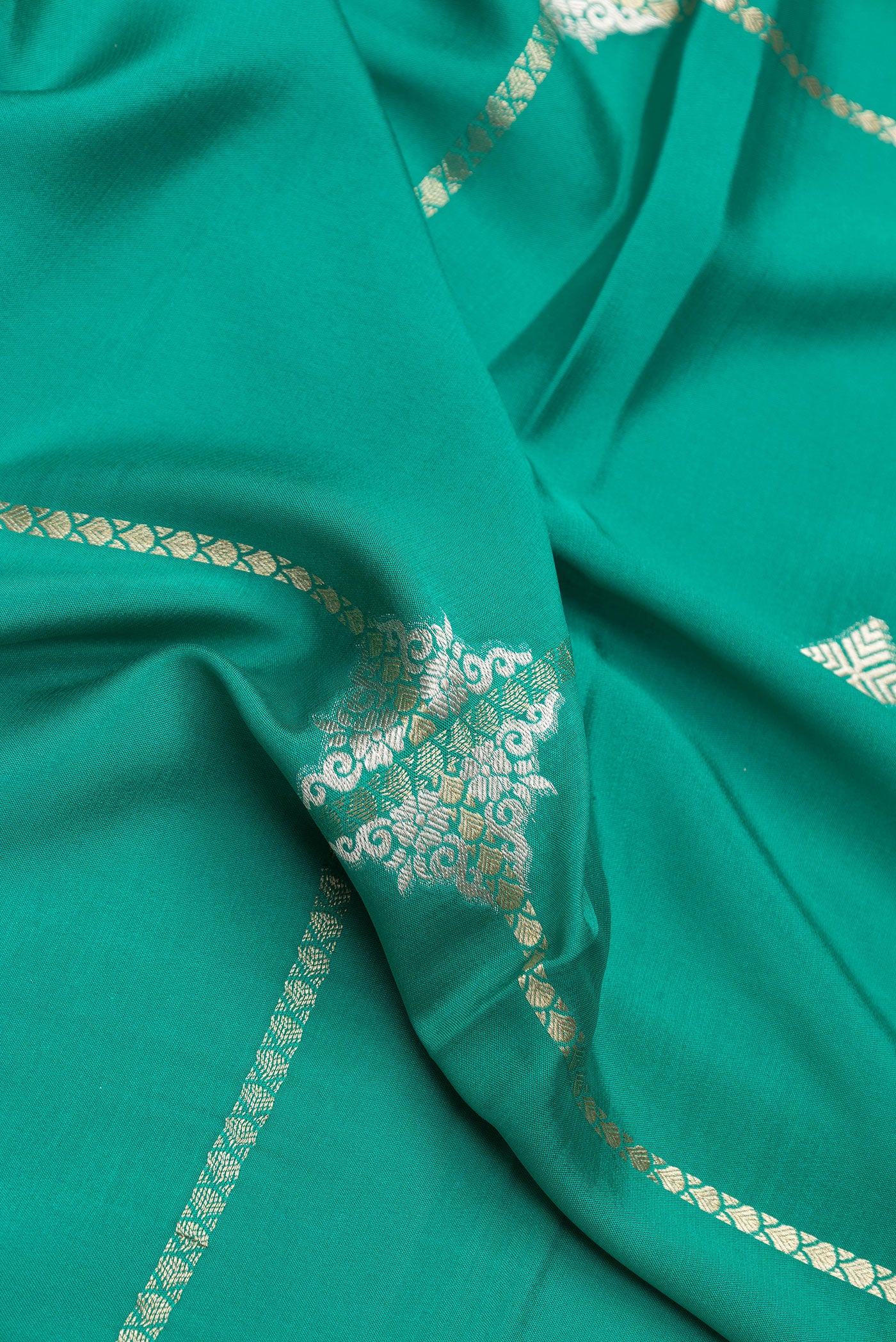 Close up of Sea Green Dual Tone Banarasi Georgette Saree with Zari Butta on the body and Zari Border.  displaying folds