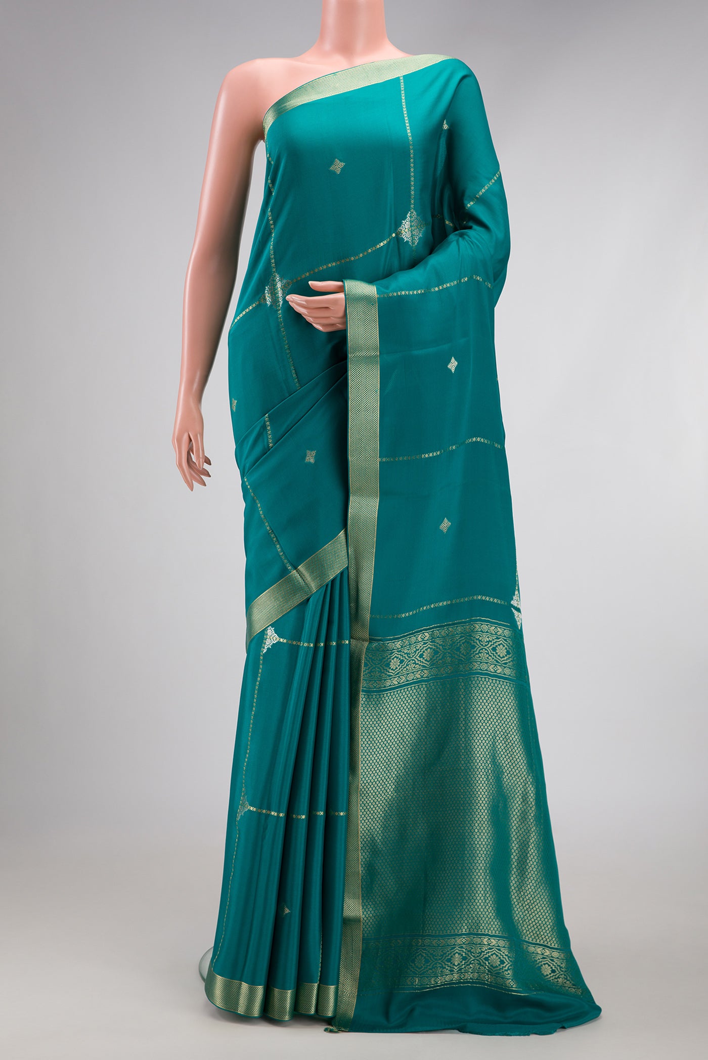 Peacock Blue Dual Tone Mysore Crepe Saree with Stripes on the body and Zari Border.  displayed on a mannequin