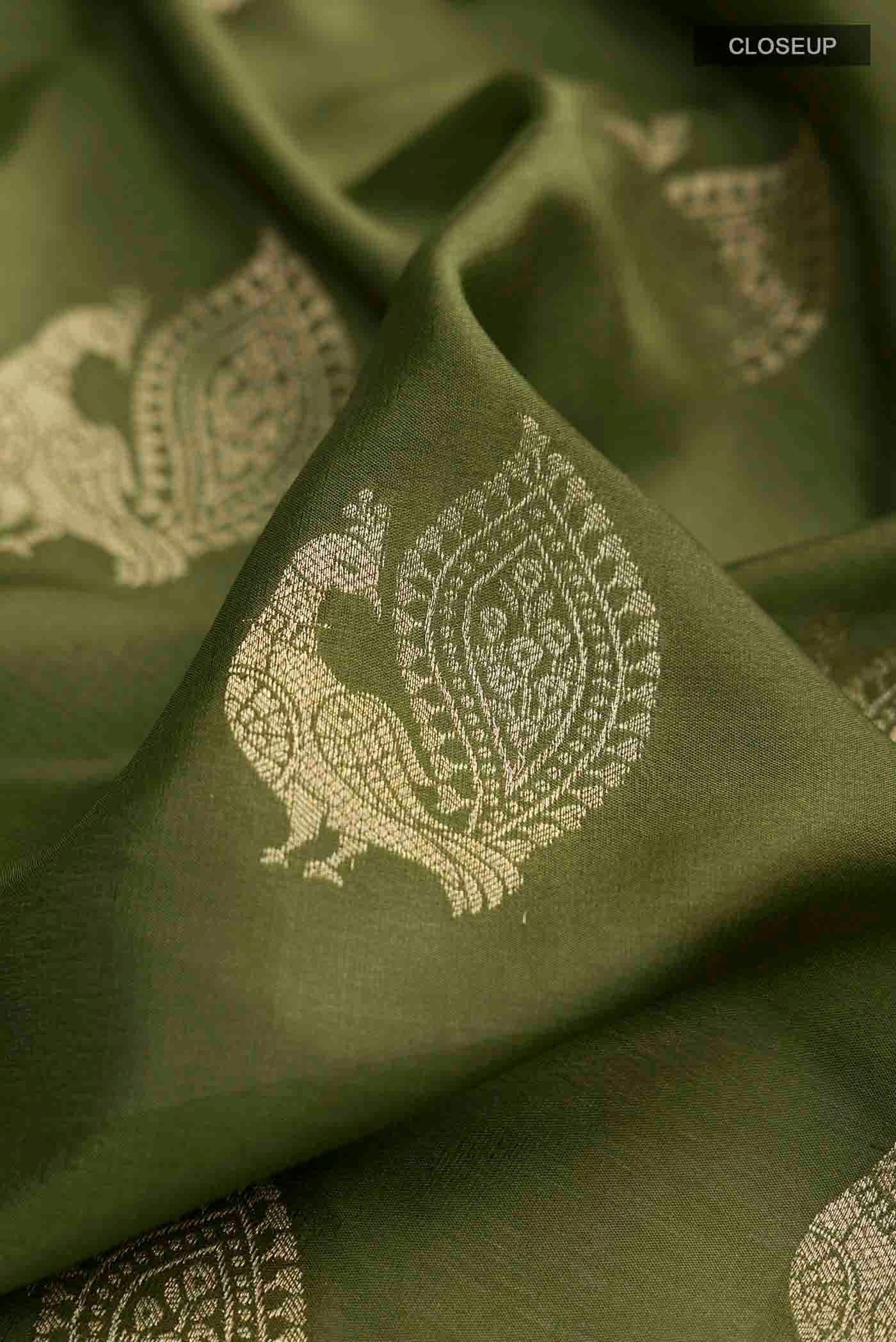 Close up of Green Mysore Crepe Saree with Zari Butta on the body and Zari Border displaying folds