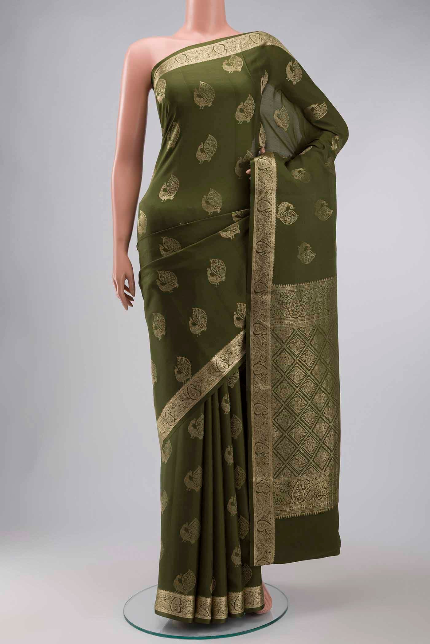 Green Mysore Crepe Saree with Zari Butta on the body and Zari Border displayed on a mannequin