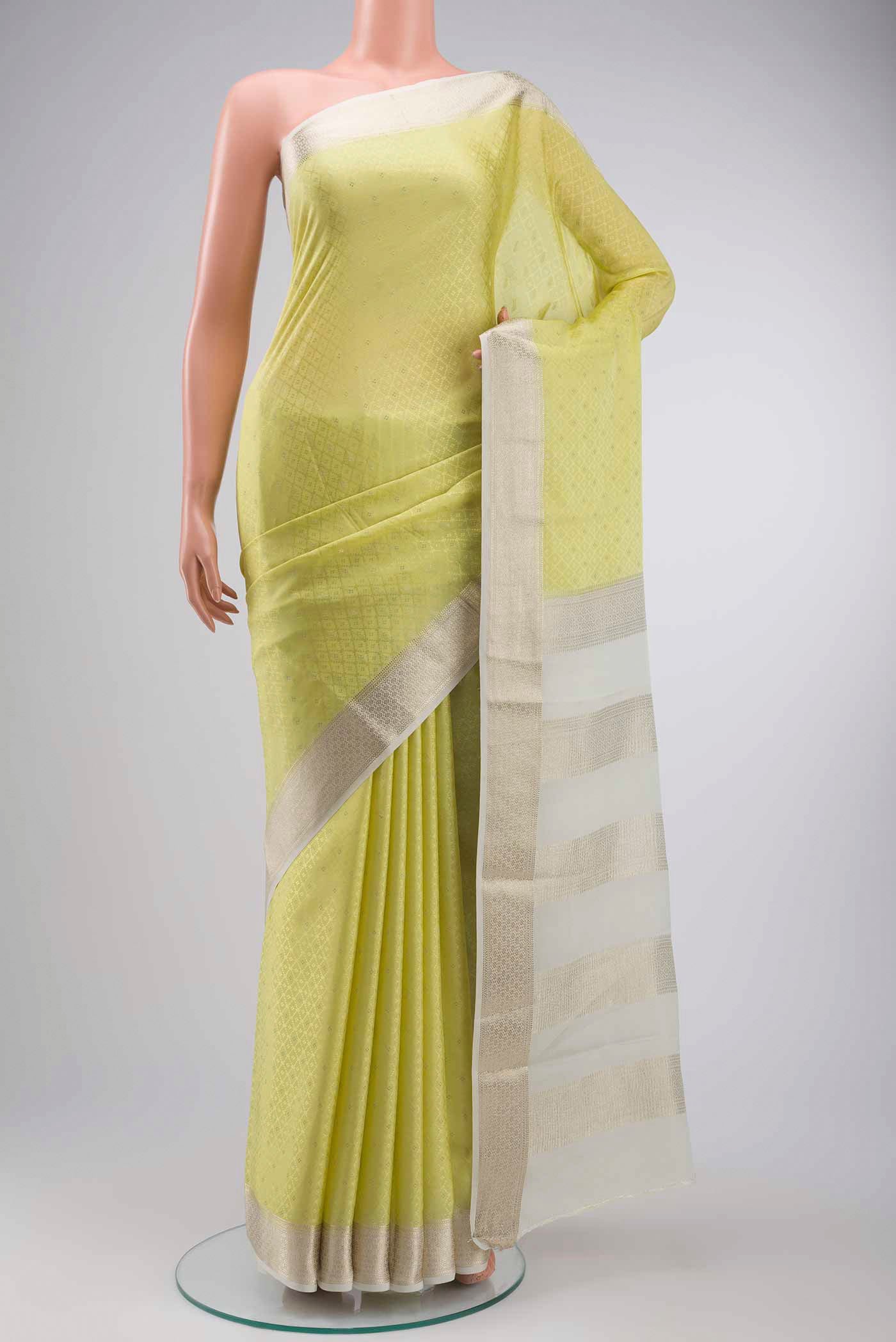 Yellow Mysore Crepe Saree with Zari Butta on the body and Zari Border displayed on a mannequin