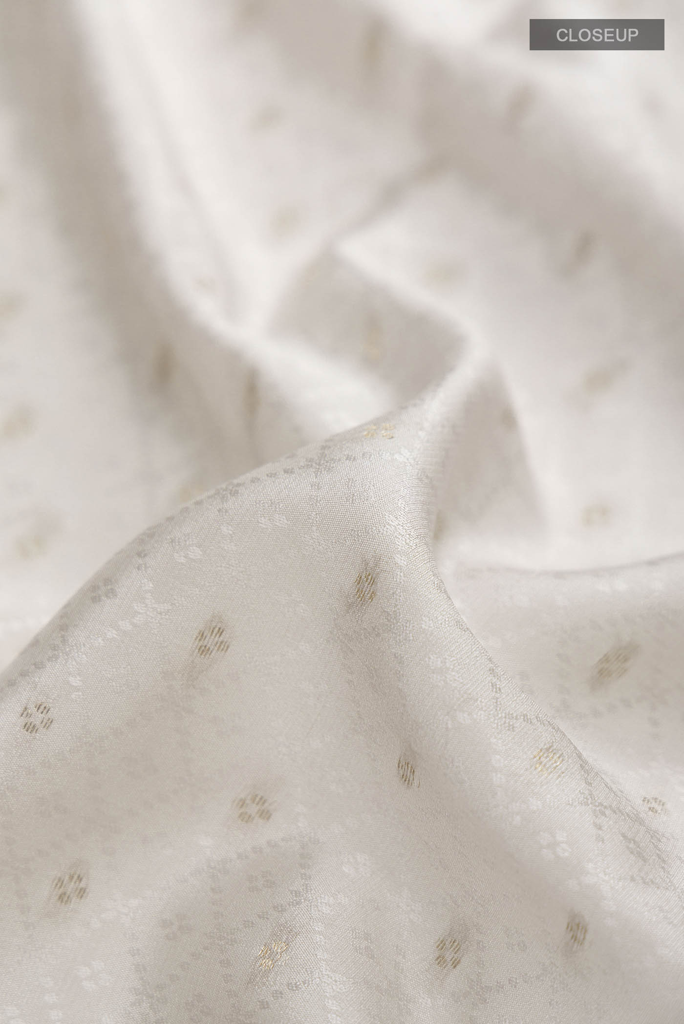 Close up of Grey Mysore Crepe Saree with Jacquard With Zari Butta on the body and Zari Border displaying folds