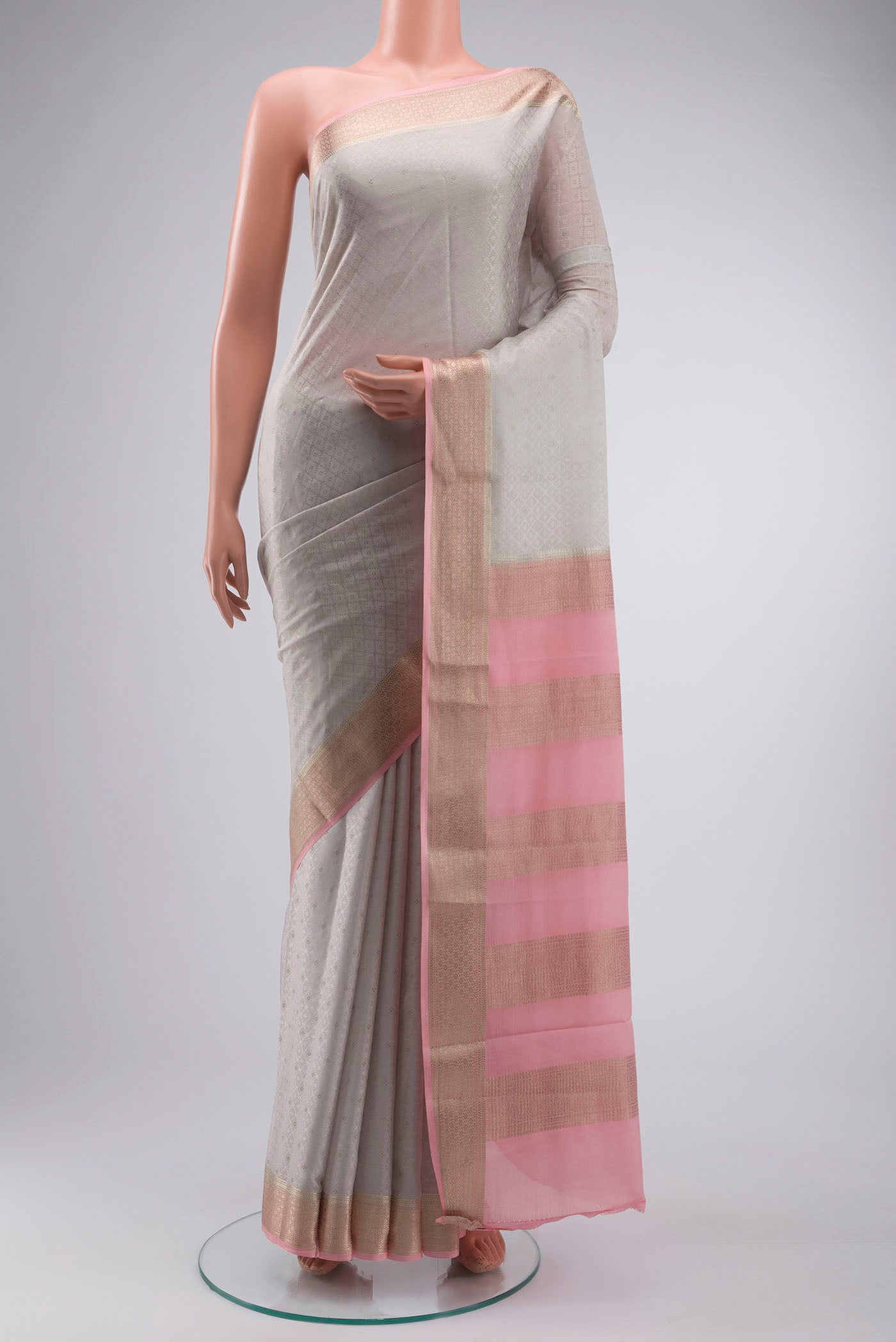 Grey Mysore Crepe Saree with Jacquard With Zari Butta on the body and Zari Border displayed on a mannequin