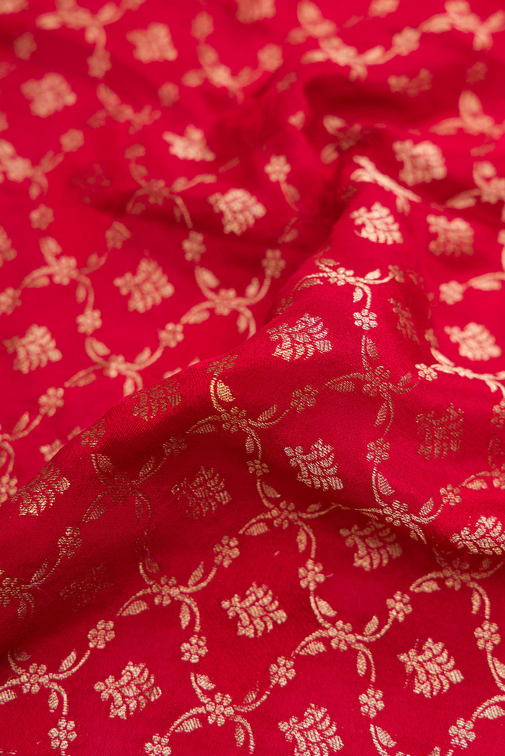 Close up of Maroon Dual Tone Georgette Saree with Zari Brocade on the body and Zari Border.  displaying folds