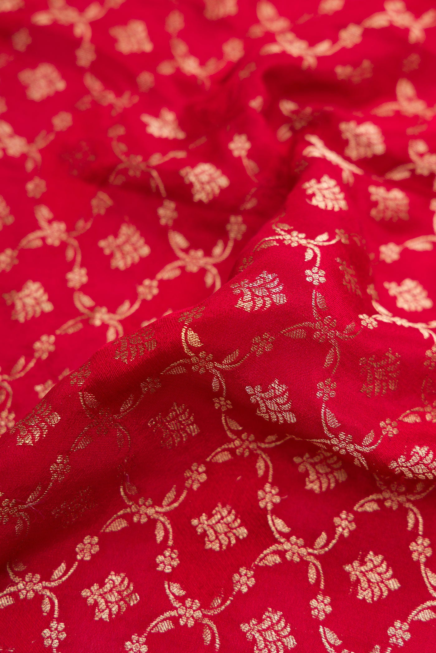 Close up of Maroon Dual Tone Georgette Saree with Zari Brocade on the body and Zari Border.  displaying folds