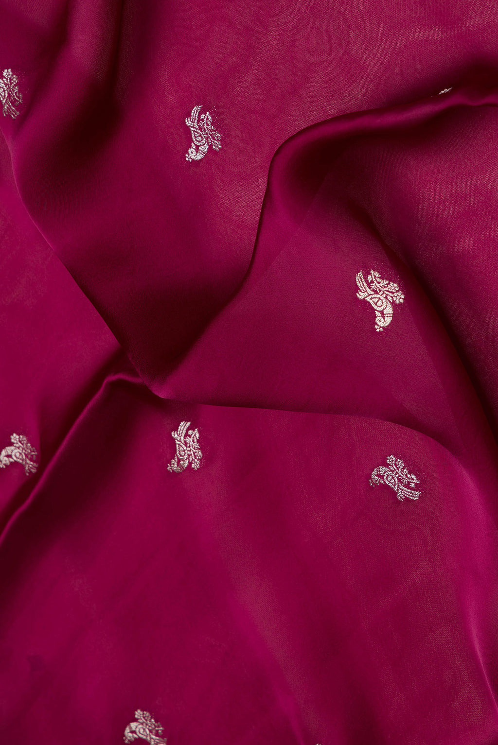 Close up of Maroon Dual Tone Blended Mysore Crepe Saree with Zari Butta on the body and Fancy Border.  displaying folds