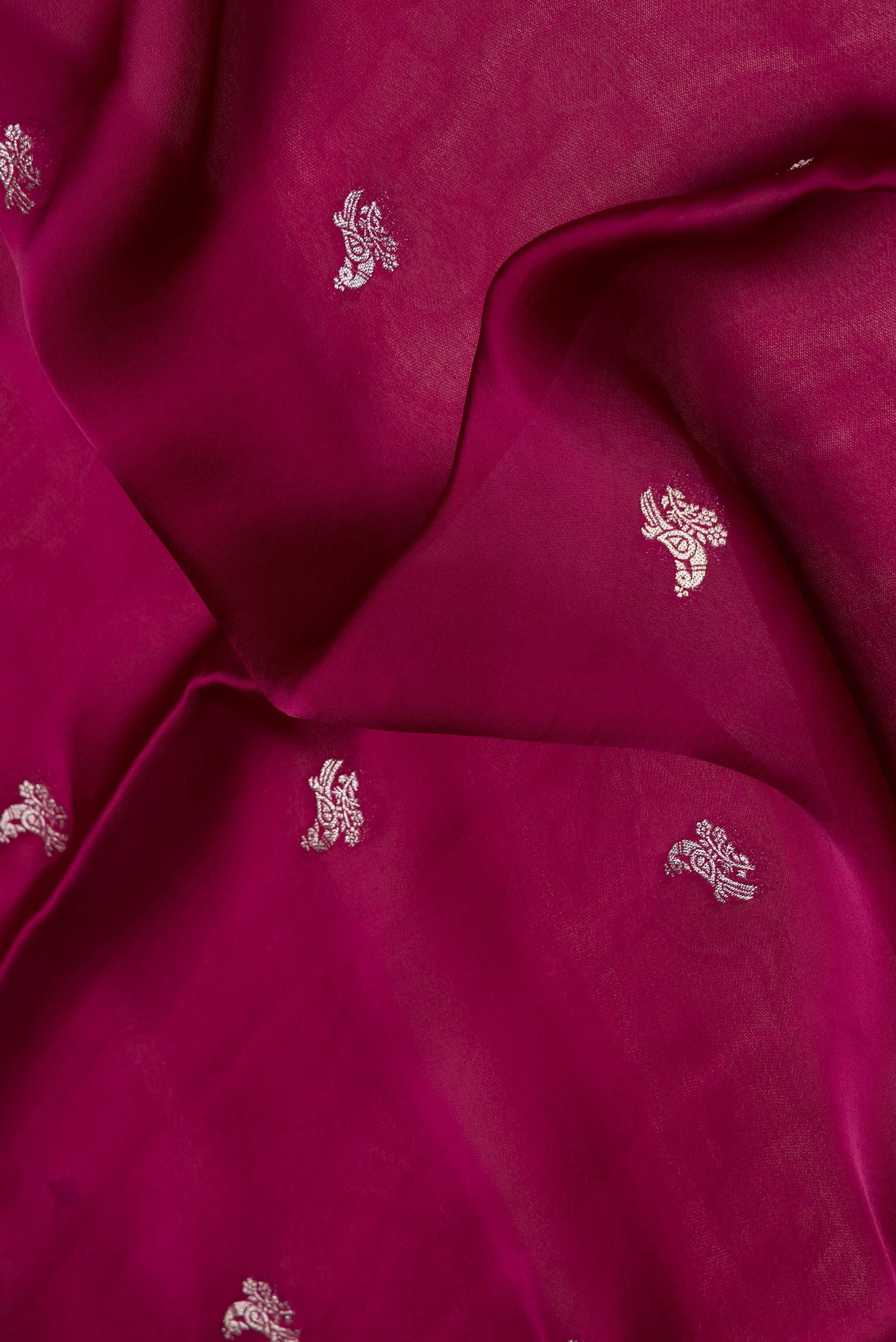 Close up of Maroon Dual Tone Blended Mysore Crepe Saree with Zari Butta on the body and Fancy Border.  displaying folds