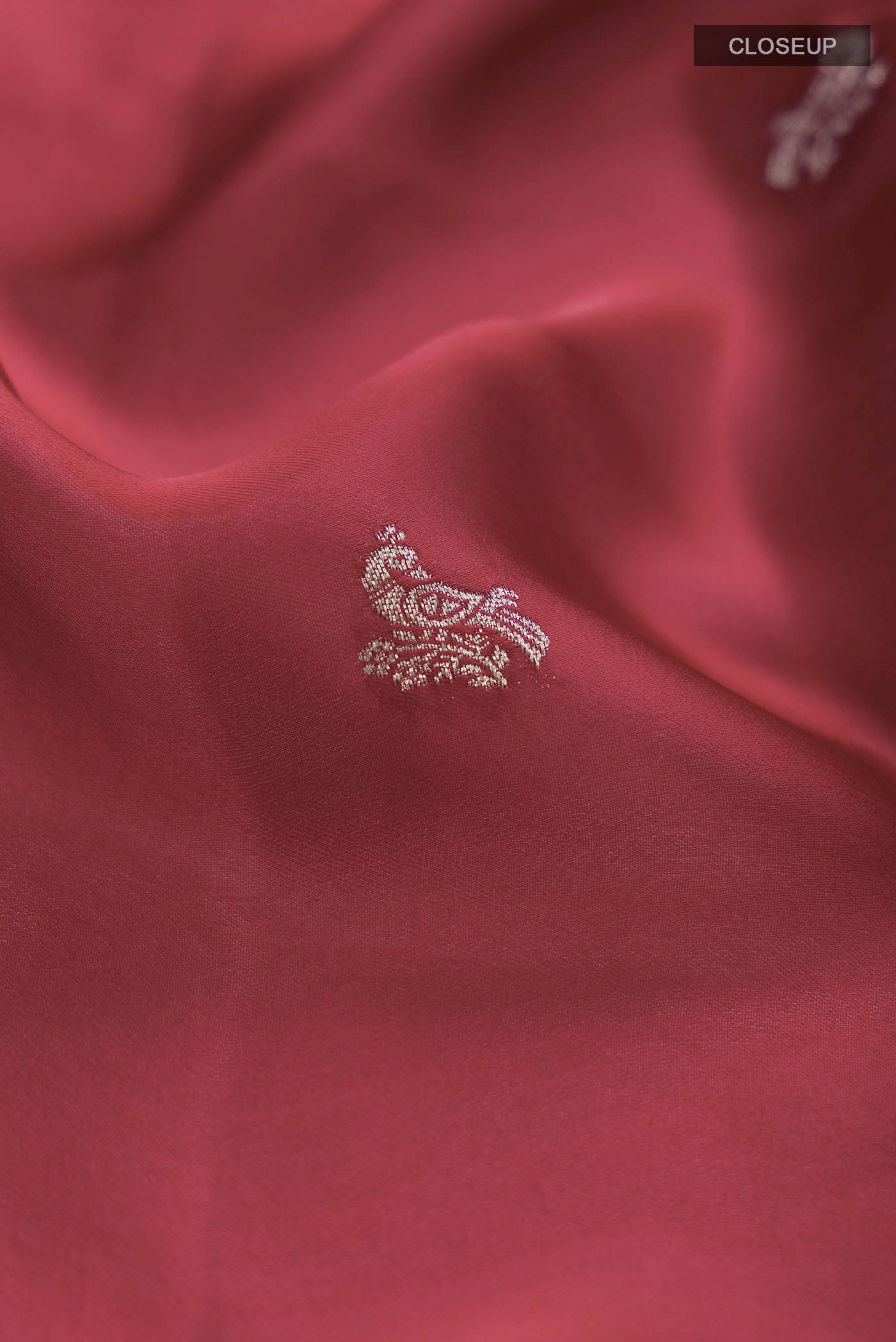 Close up of Red Satin Silk Saree with Zari Butta on the body and Zari Border displaying folds