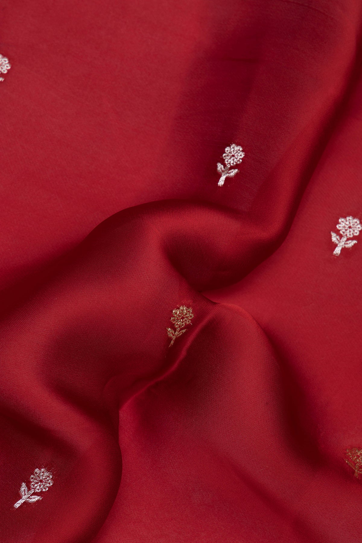 Close up of Maroon Dual Tone Blended Satin Silk Saree with Zari Butta on the body and Zari Border.  displaying folds