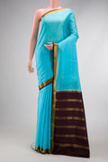 Sky Blue Mysore Crepe Saree with Zari Butta on the body and Zari Border.  displayed on a mannequin