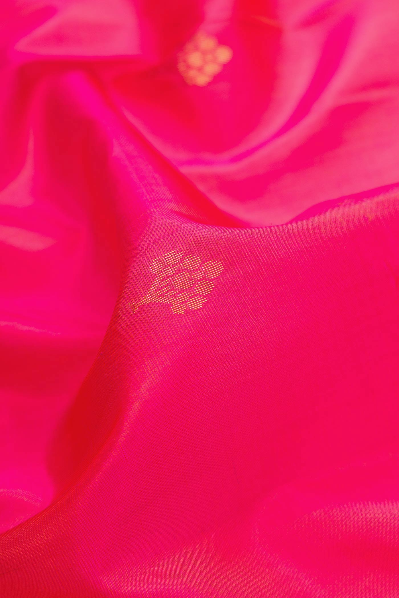 Close up of Pink Dual Tone Soft Silk Saree with Zari Butta on the body and Fancy Border.  displaying folds