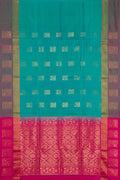 Peacock Blue Dual Tone Soft Silk Saree with Zari Butta on the body and Fancy Border.  displayed on a mannequin