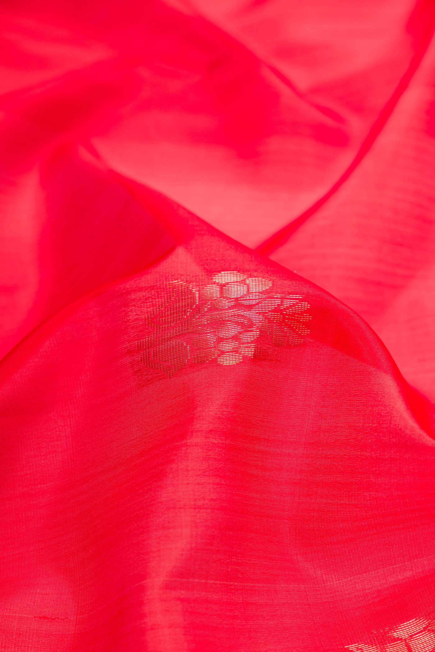 Close up of Red Dual Tone Soft Silk Saree with Zari Butta on the body and Zari Border.  displaying folds